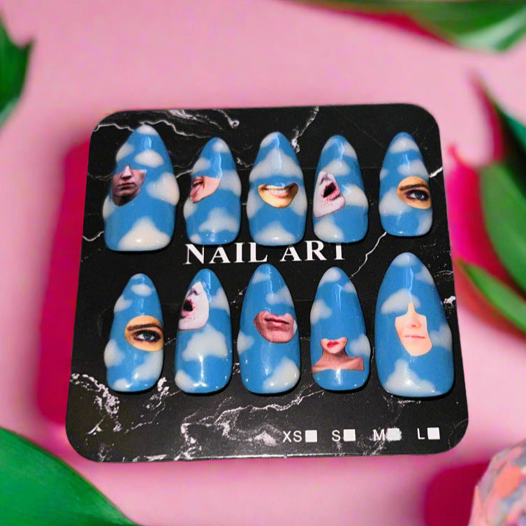 Pack of blue nail art designs with faces on a pink background These cut-out collage style press-on nails combine whimsical surrealism with a grunge Y2K edge. Over soft blue skies, faces, mouths, eyes, and lips float like rebellious daydreams — a perfect blend of ethereal whimsy and punk collage energy.