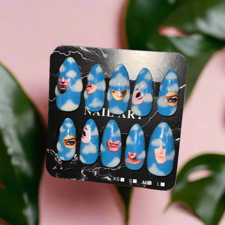 Set of blue nail art designs on a display card with a person wearing them.