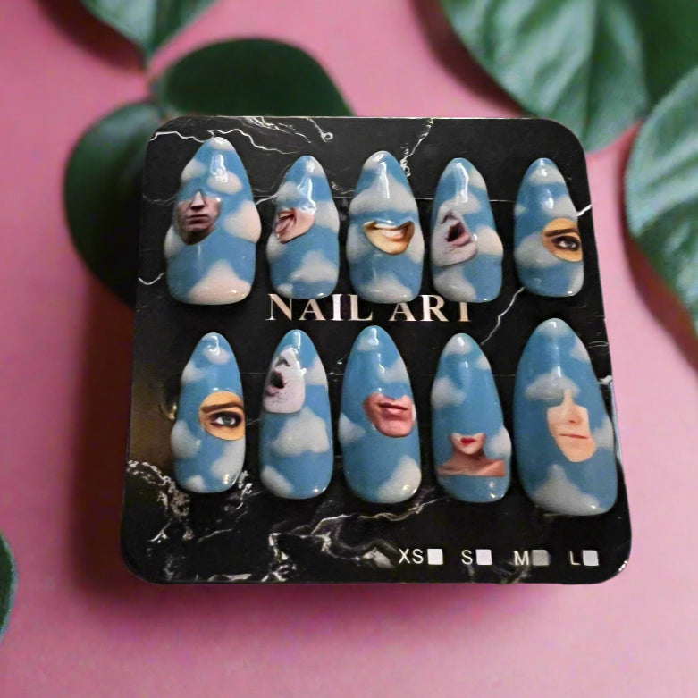 Set of blue and white nail art designs on a black tray with a camouflage background.