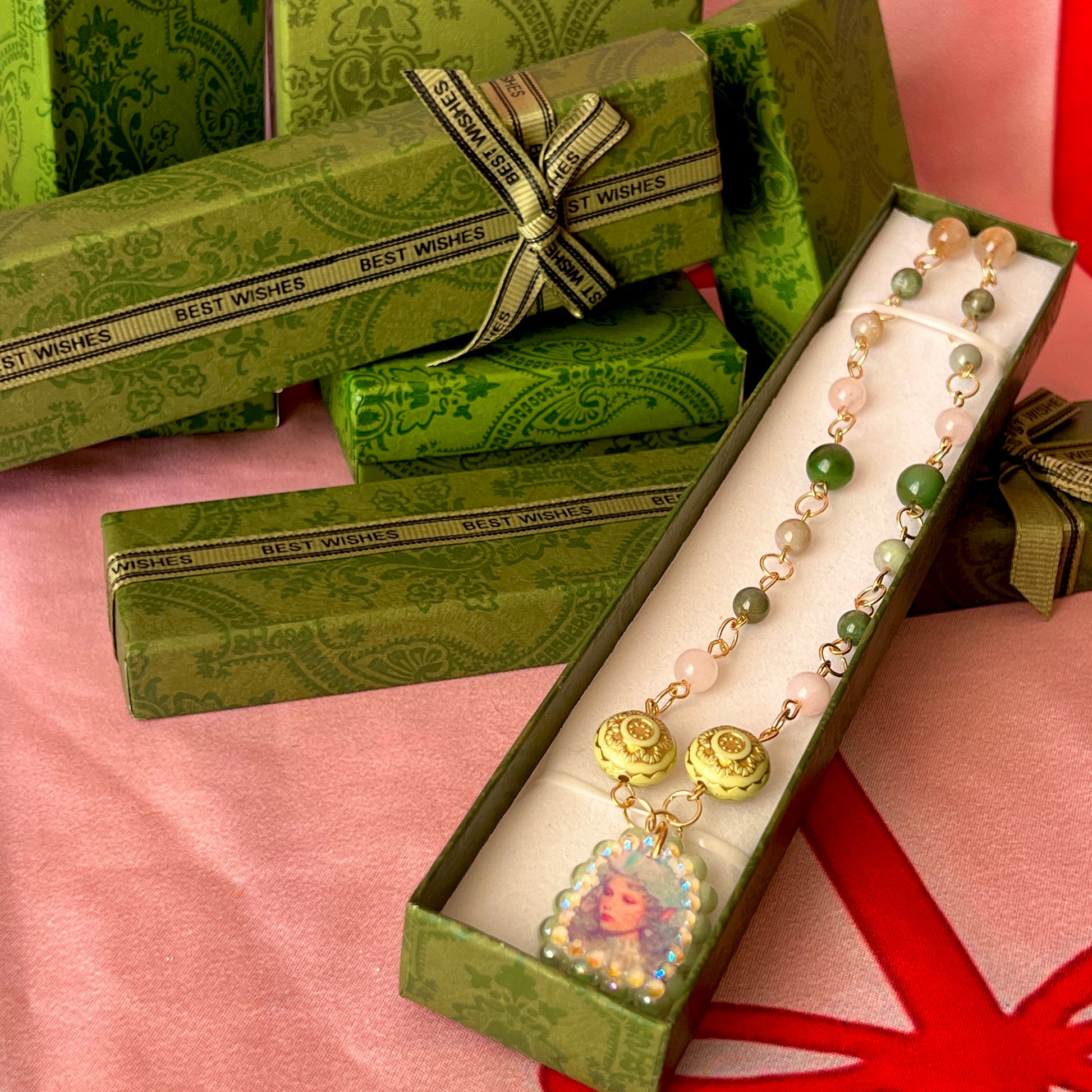 Fairycore crystal portrait necklace — 20" beaded necklace with rose quartz, Indian agate, and upcycled rutilated quartz plus handmade iridescent bedazzled portrait charm. 18k gold plated findings + 18k gold filled jump rings; ornate toggle clasp. Gift-ready green Victorian-style box; ready to ship.