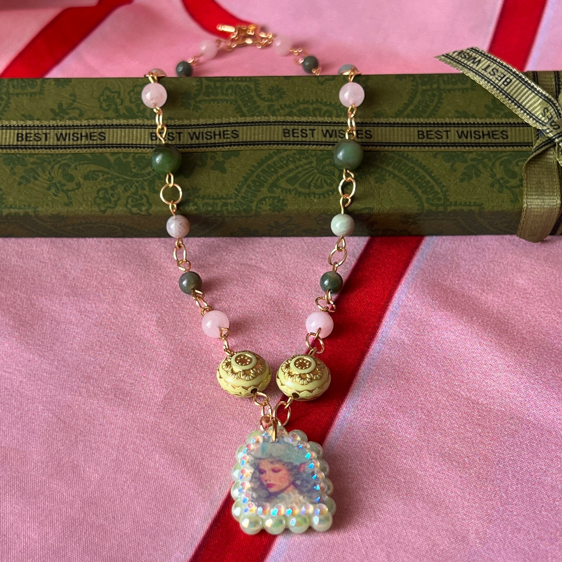 Fairycore crystal portrait necklace — 20" beaded necklace with rose quartz, Indian agate, and upcycled rutilated quartz plus handmade iridescent bedazzled portrait charm. 18k gold plated findings + 18k gold filled jump rings; ornate toggle clasp. Gift-ready green Victorian-style box; ready to ship.
