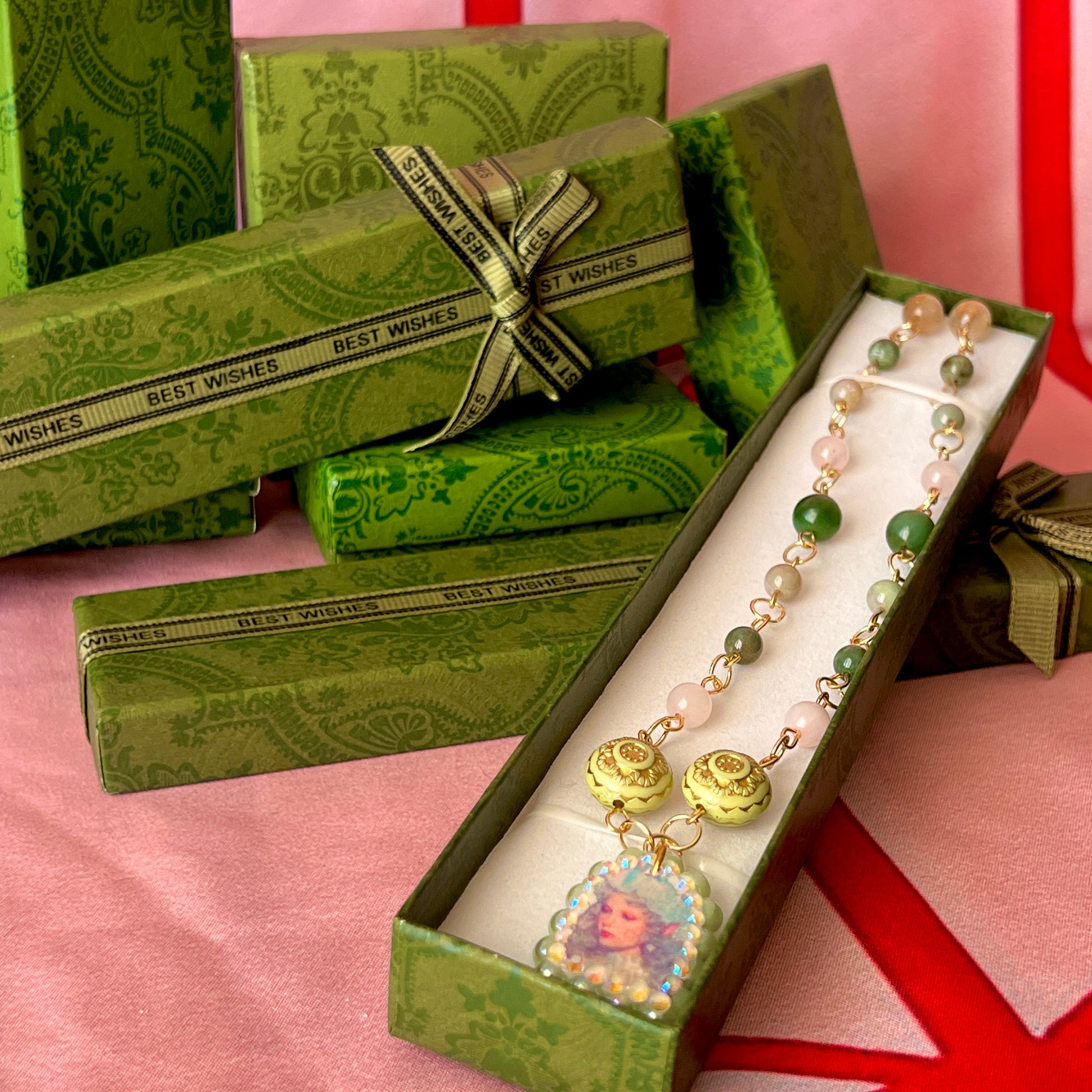 Fairycore crystal portrait necklace — 20" beaded necklace with rose quartz, Indian agate, and upcycled rutilated quartz plus handmade iridescent bedazzled portrait charm. 18k gold plated findings + 18k gold filled jump rings; ornate toggle clasp. Gift-ready green Victorian-style box; ready to ship.