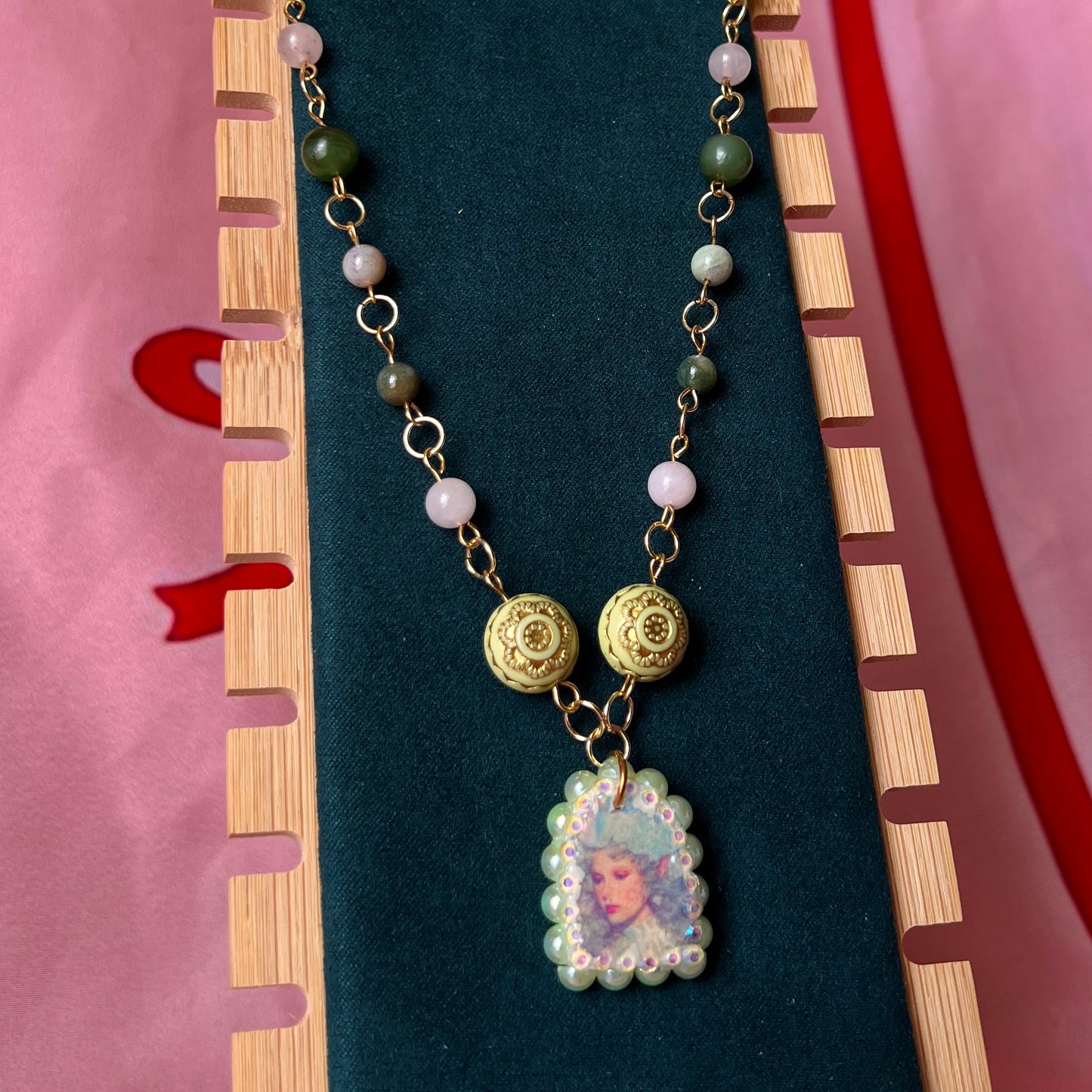 Fairycore crystal portrait necklace — 20" beaded necklace with rose quartz, Indian agate, and upcycled rutilated quartz plus handmade iridescent bedazzled portrait charm. 18k gold plated findings + 18k gold filled jump rings; ornate toggle clasp. Gift-ready green Victorian-style box; ready to ship.