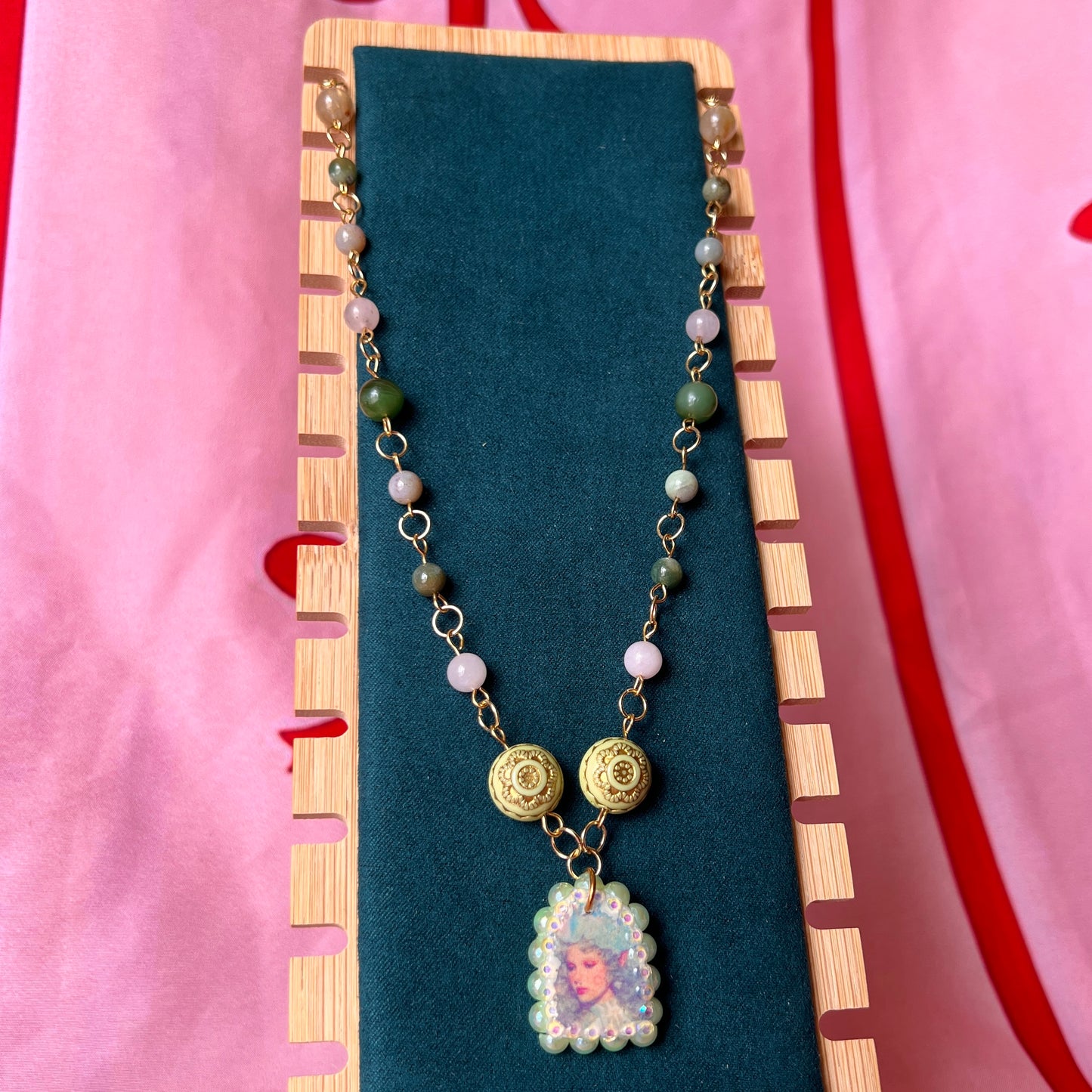 Fairycore crystal portrait necklace — 20" beaded necklace with rose quartz, Indian agate, and upcycled rutilated quartz plus handmade iridescent bedazzled portrait charm. 18k gold plated findings + 18k gold filled jump rings; ornate toggle clasp. Gift-ready green Victorian-style box; ready to ship.