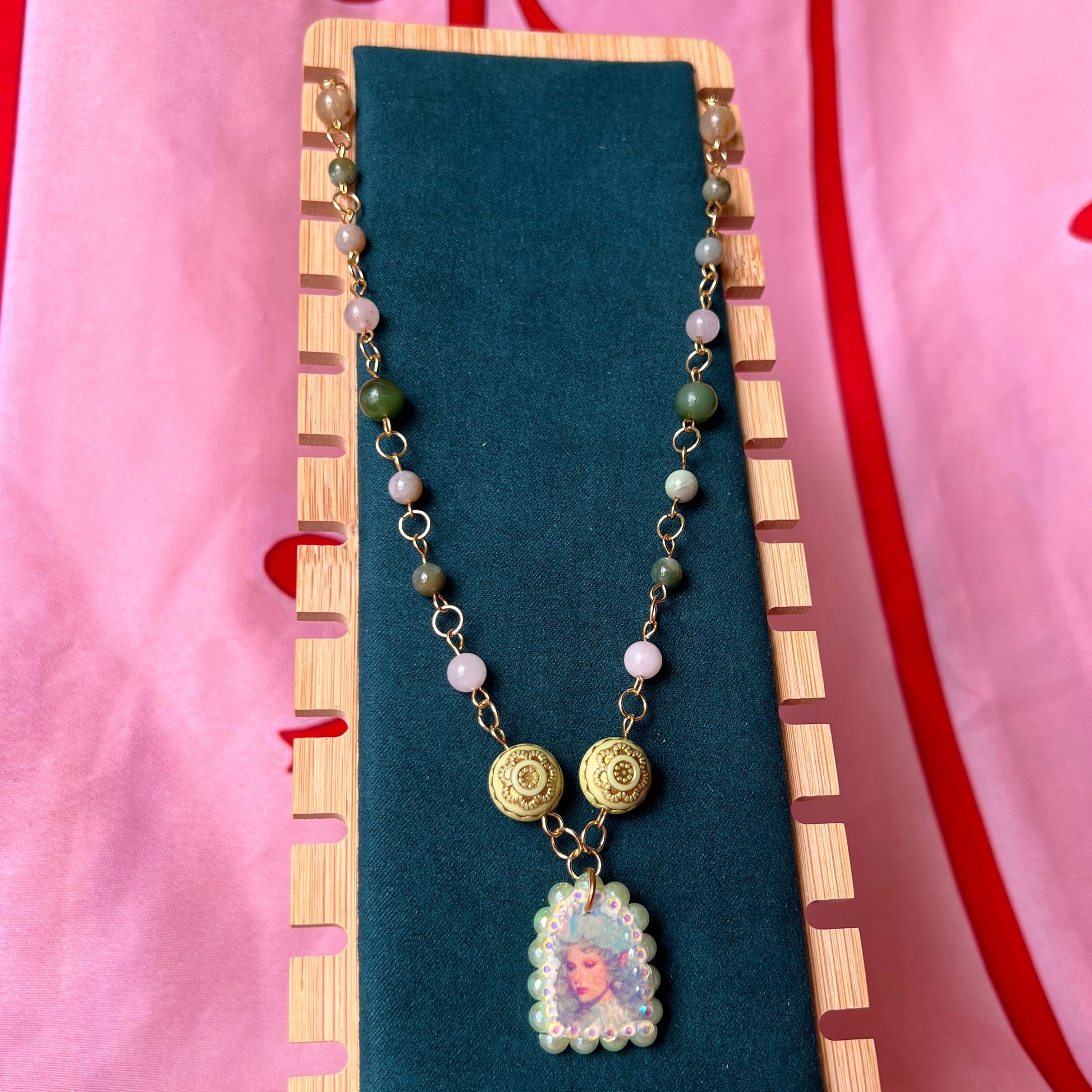 Fairycore crystal portrait necklace — 20" beaded necklace with rose quartz, Indian agate, and upcycled rutilated quartz plus handmade iridescent bedazzled portrait charm. 18k gold plated findings + 18k gold filled jump rings; ornate toggle clasp. Gift-ready green Victorian-style box; ready to ship.