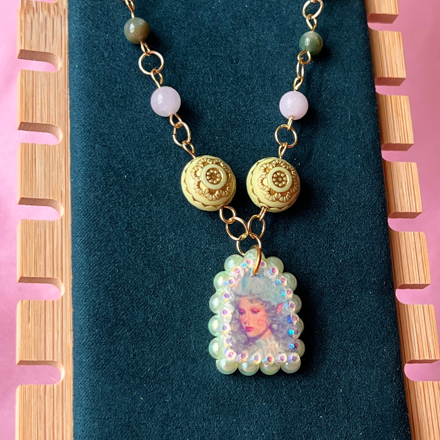Fairycore crystal portrait necklace — 20" beaded necklace with rose quartz, Indian agate, and upcycled rutilated quartz plus handmade iridescent bedazzled portrait charm. 18k gold plated findings + 18k gold filled jump rings; ornate toggle clasp. Gift-ready green Victorian-style box; ready to ship.