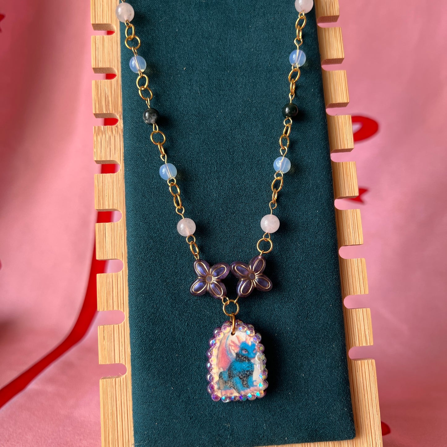 Gold plated dragon charm necklace — one-of-a-kind beaded necklace with rose quartz, opalite, and Indian agate plus handmade iridescent polymer clay dragon charm bedazzled with iridescent pearls, dark purple pearls, and rhinestones. 18k gold-plated links; 20" length + 2" star extender. Ready to ship.