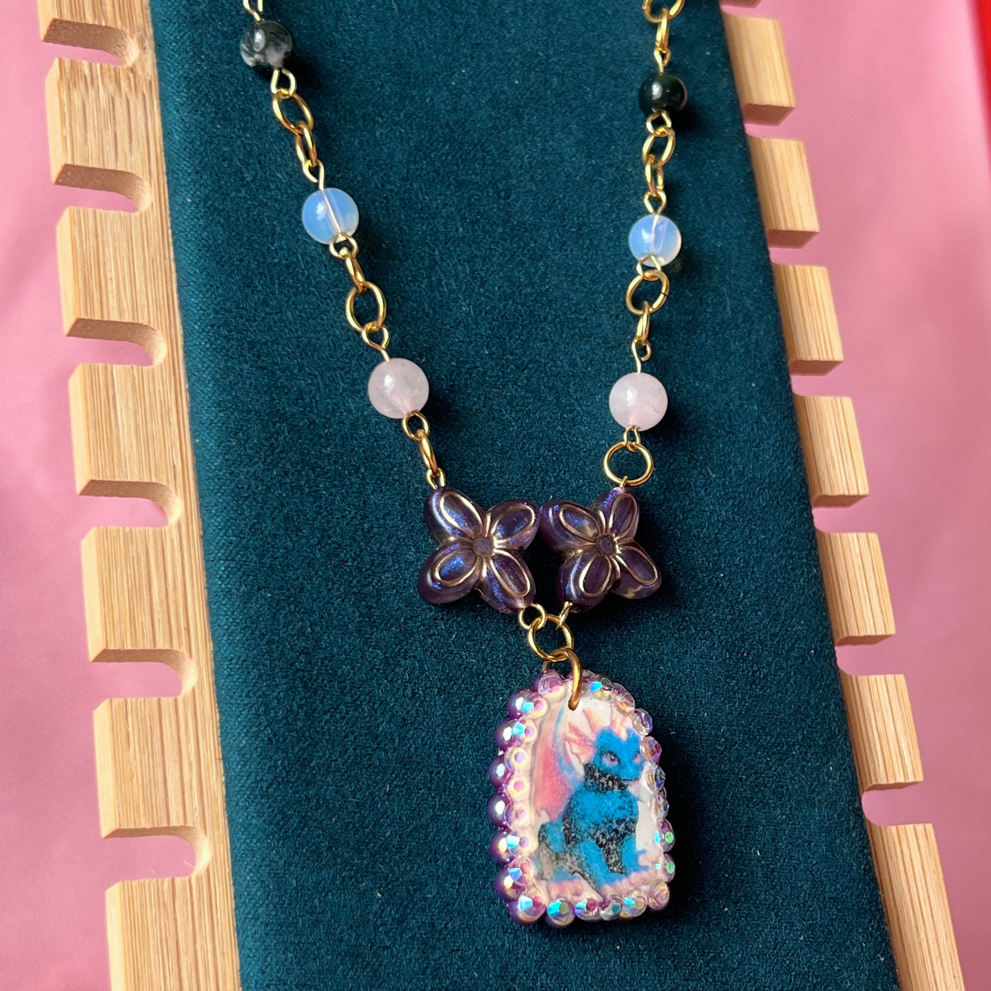 Gold plated dragon charm necklace — one-of-a-kind beaded necklace with rose quartz, opalite, and Indian agate plus handmade iridescent polymer clay dragon charm bedazzled with iridescent pearls, dark purple pearls, and rhinestones. 18k gold-plated links; 20" length + 2" star extender. Ready to ship.