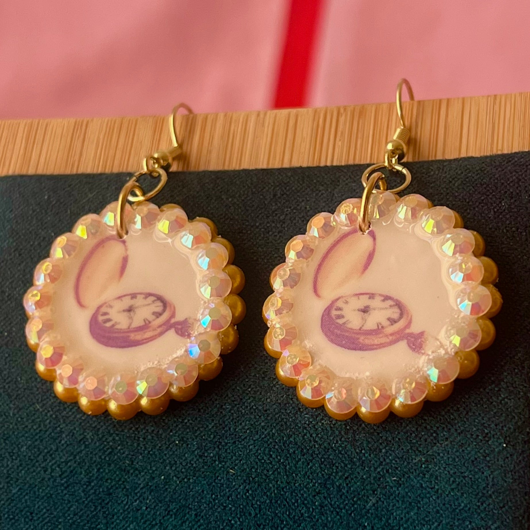 Handmade golden compass charm earrings featuring polymer‑clay image transfer, a 1‑inch circle charm framed with golden pearls and rhinestones, 18k gold‑plated hypoallergenic findings, and a balanced, luxuriously weighted feel—perfect nautical‑core, travel‑talisman, gold statement jewelry for a meaningful, sparkly look.