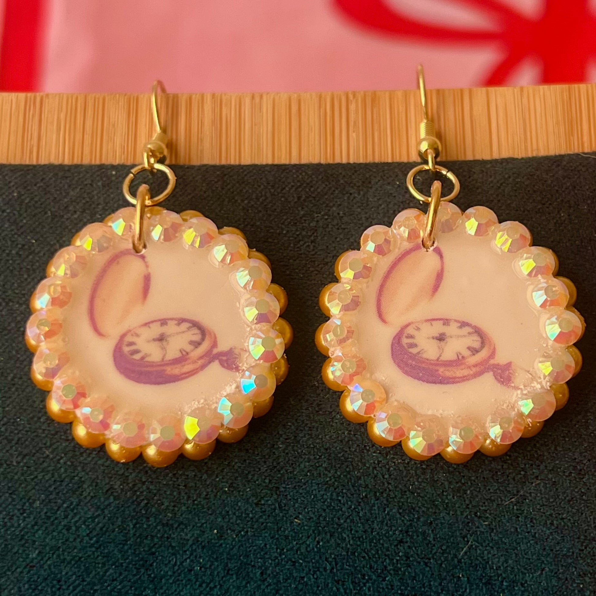 Handmade golden compass charm earrings featuring polymer‑clay image transfer, a 1‑inch circle charm framed with golden pearls and rhinestones, 18k gold‑plated hypoallergenic findings, and a balanced, luxuriously weighted feel—perfect nautical‑core, travel‑talisman, gold statement jewelry for a meaningful, sparkly look.