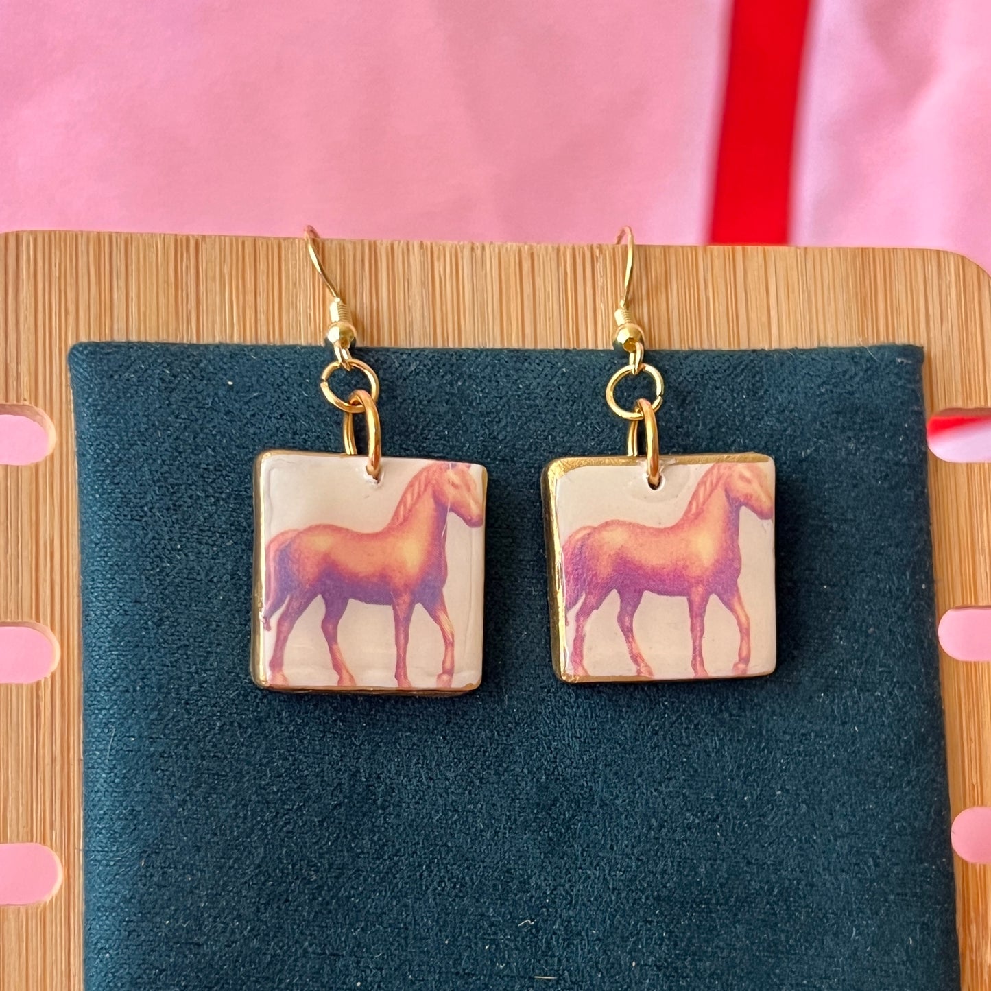 Handmade golden toy horse earrings with polymer‑clay mini horse charms painted in metallic gold, featuring gold‑plated hypoallergenic hooks—dreamcore, trinketcore, nostalgic jewelry perfect for collectors.