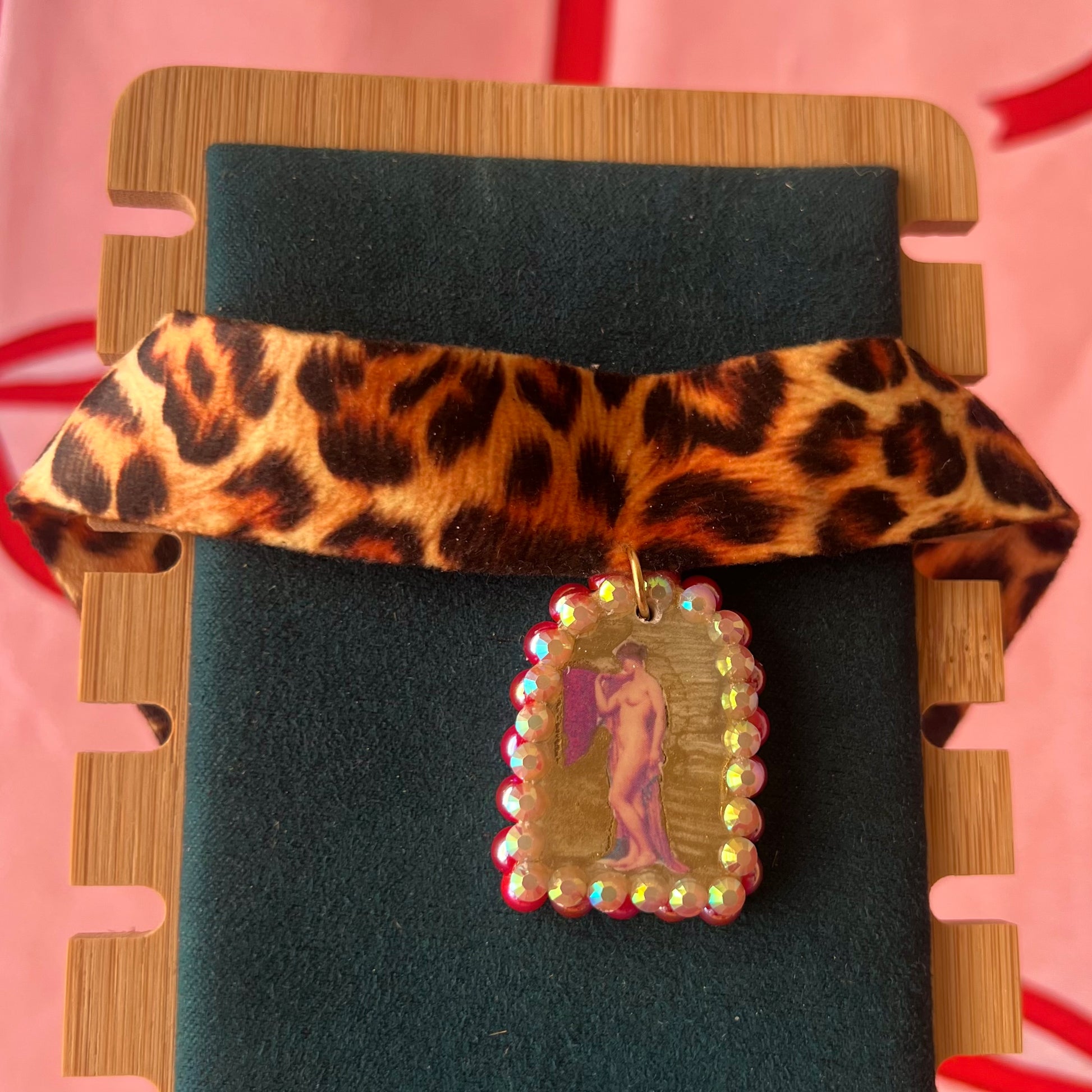 High Jungle Priestess choker — soft cheetah print choker with handmade polymer clay charm featuring neoclassical painting element, framed with bright red pearls. Adjustable fit ~14–16" with extension chain. Gift-ready green Victorian-patterned box + bow. Ready to ship in 1–3 days.