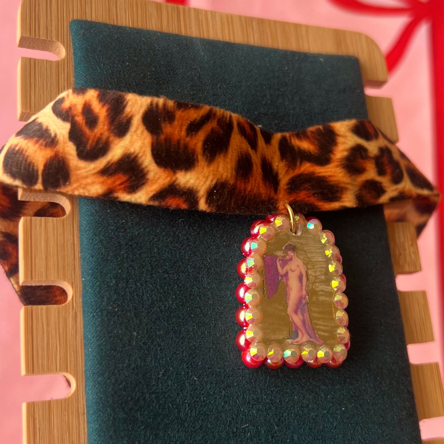 High Jungle Priestess choker — soft cheetah print choker with handmade polymer clay charm featuring neoclassical painting element, framed with bright red pearls. Adjustable fit ~14–16" with extension chain. Gift-ready green Victorian-patterned box + bow. Ready to ship in 1–3 days.