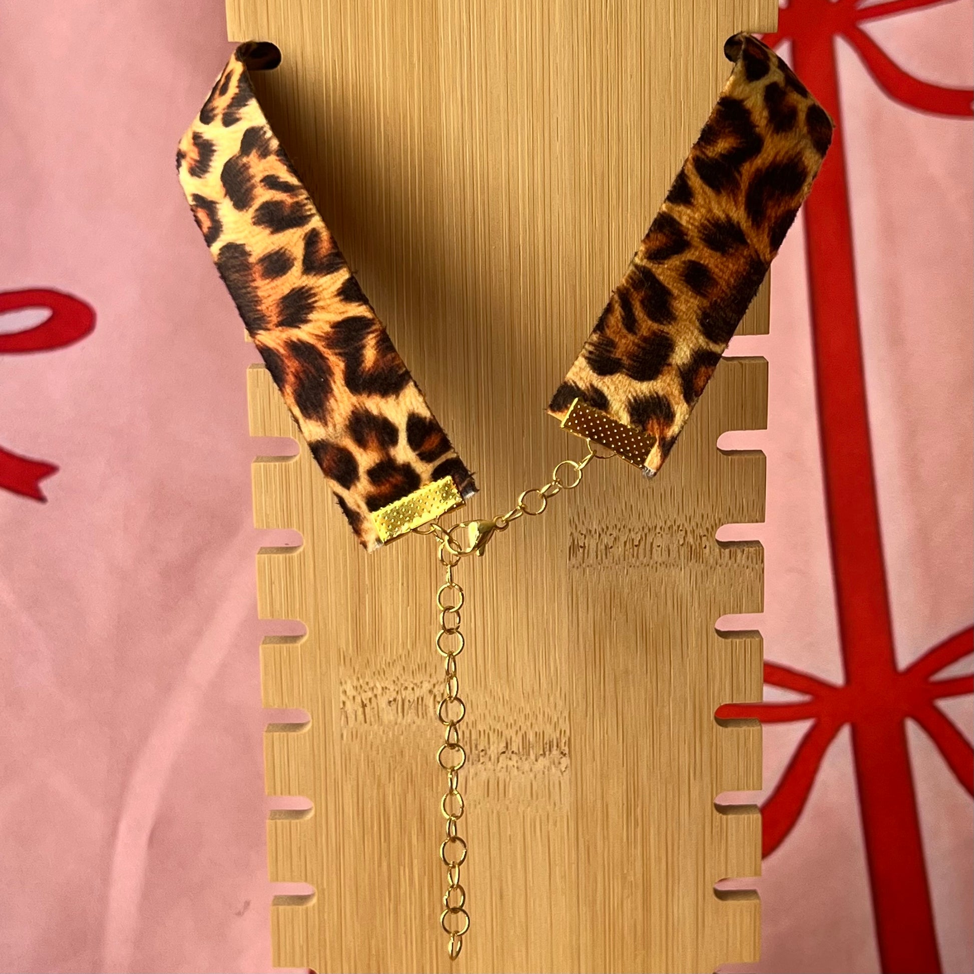 High Jungle Priestess choker — soft cheetah print choker with handmade polymer clay charm featuring neoclassical painting element, framed with bright red pearls. Adjustable fit ~14–16" with extension chain. Gift-ready green Victorian-patterned box + bow. Ready to ship in 1–3 days.