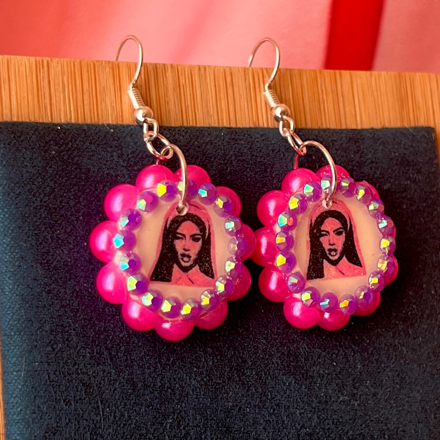 Alt text: Hot pink Y2K nun earrings featuring handmade polymer clay charms bedazzled with iridescent beads, silver plated hypoallergenic hooks, and whimsical gothic, grunge, punk, pink, Y2K style—perfect gift‑ready earrings in a cute green Victorian‑patterned box.