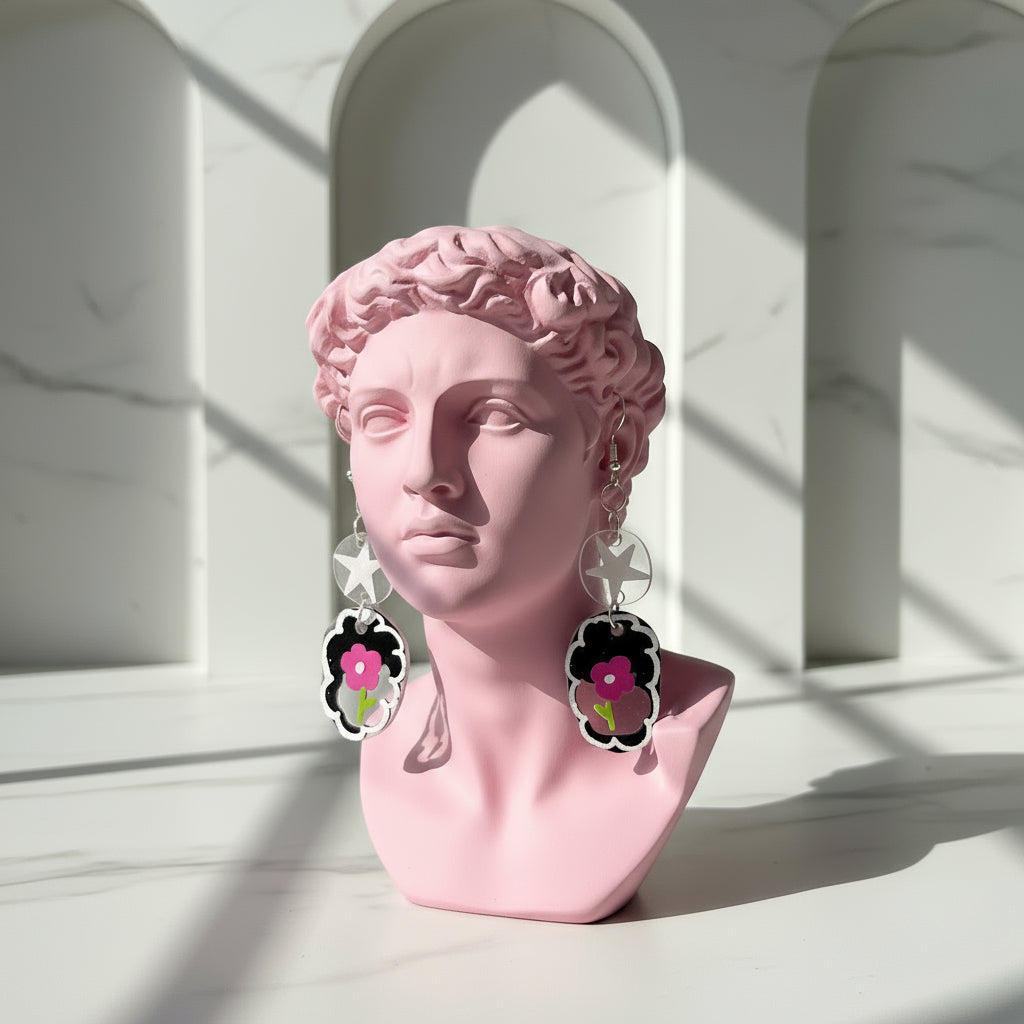 Pink bust with floral earrings against a light architectural background