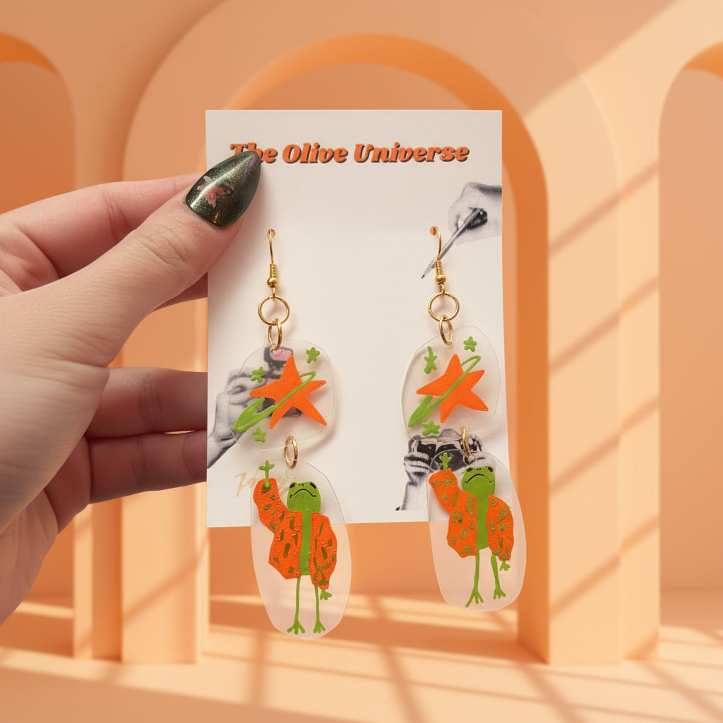 “Reaching for the Star" — Hand-Drawn Cosmic Puffer Frog Earrings