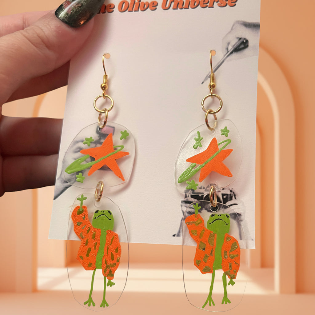 “Reaching for the Star" — Hand-Drawn Cosmic Puffer Frog Earrings