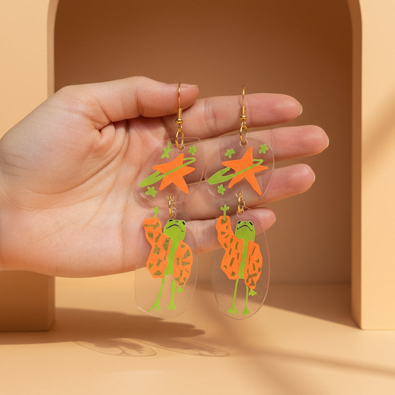 “Reaching for the Star" — Hand-Drawn Cosmic Puffer Frog Earrings