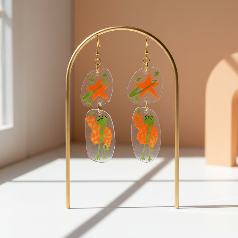 “Reaching for the Star" — Hand-Drawn Cosmic Puffer Frog Earrings