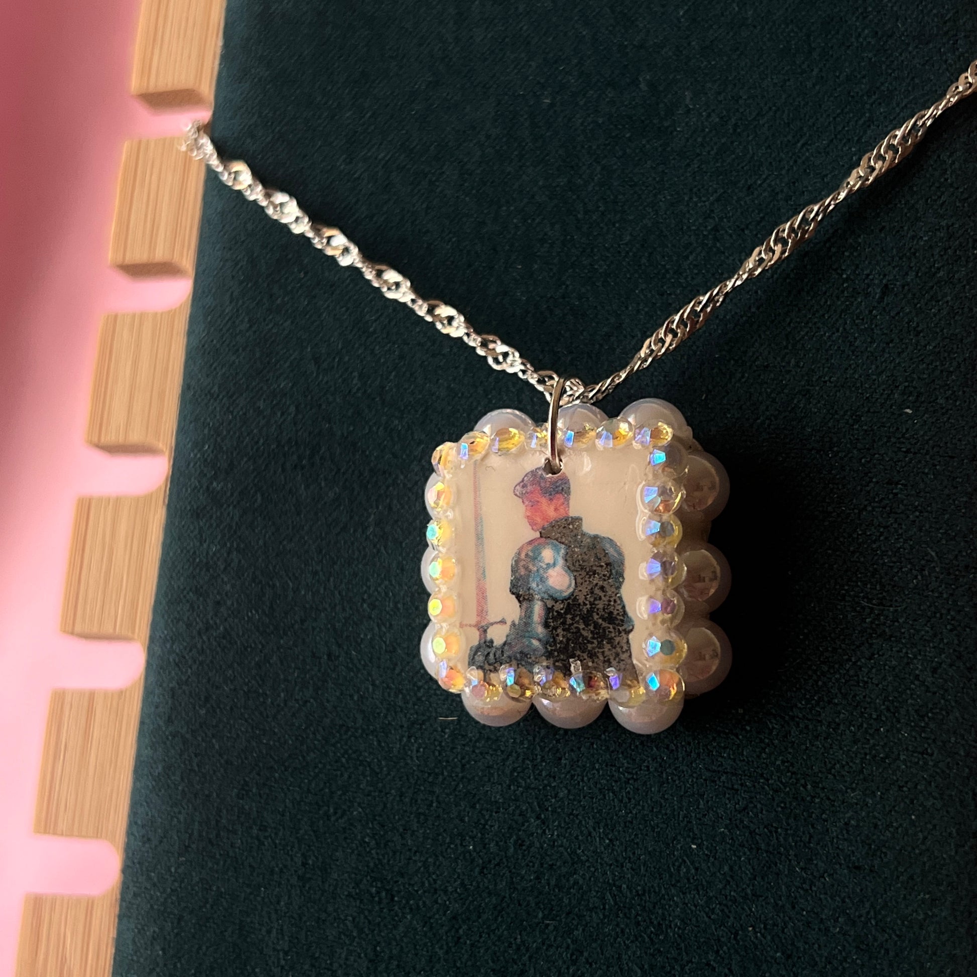 Iridescent knight & sword necklace — handmade polymer clay knight + sword charms bedazzled with iridescent beads on 20" 925 silver chain. Gift-ready green Victorian-patterned box. Fairycore coquette cottagecore Y2K charm necklace; ready to ship in 1–3 business days.