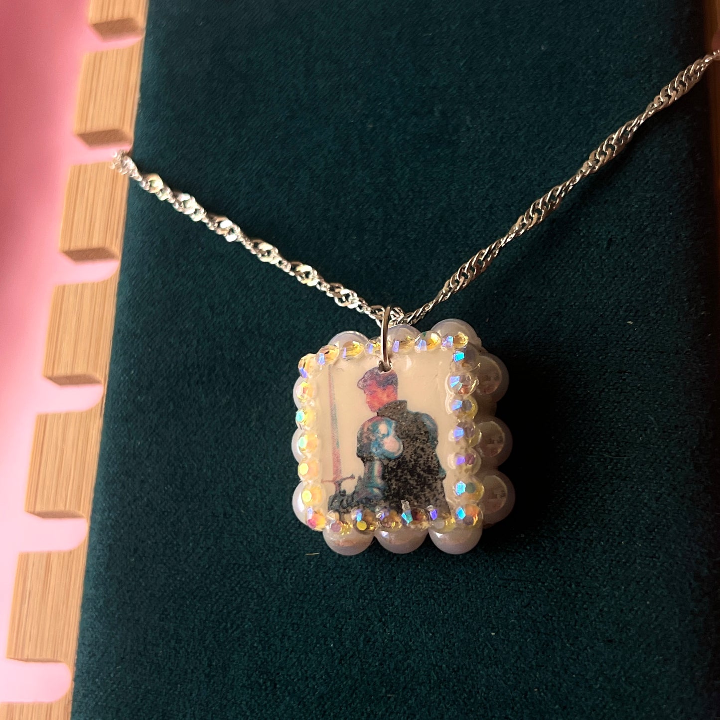 Iridescent knight & sword necklace — handmade polymer clay knight + sword charms bedazzled with iridescent beads on 20" 925 silver chain. Gift-ready green Victorian-patterned box. Fairycore coquette cottagecore Y2K charm necklace; ready to ship in 1–3 business days.