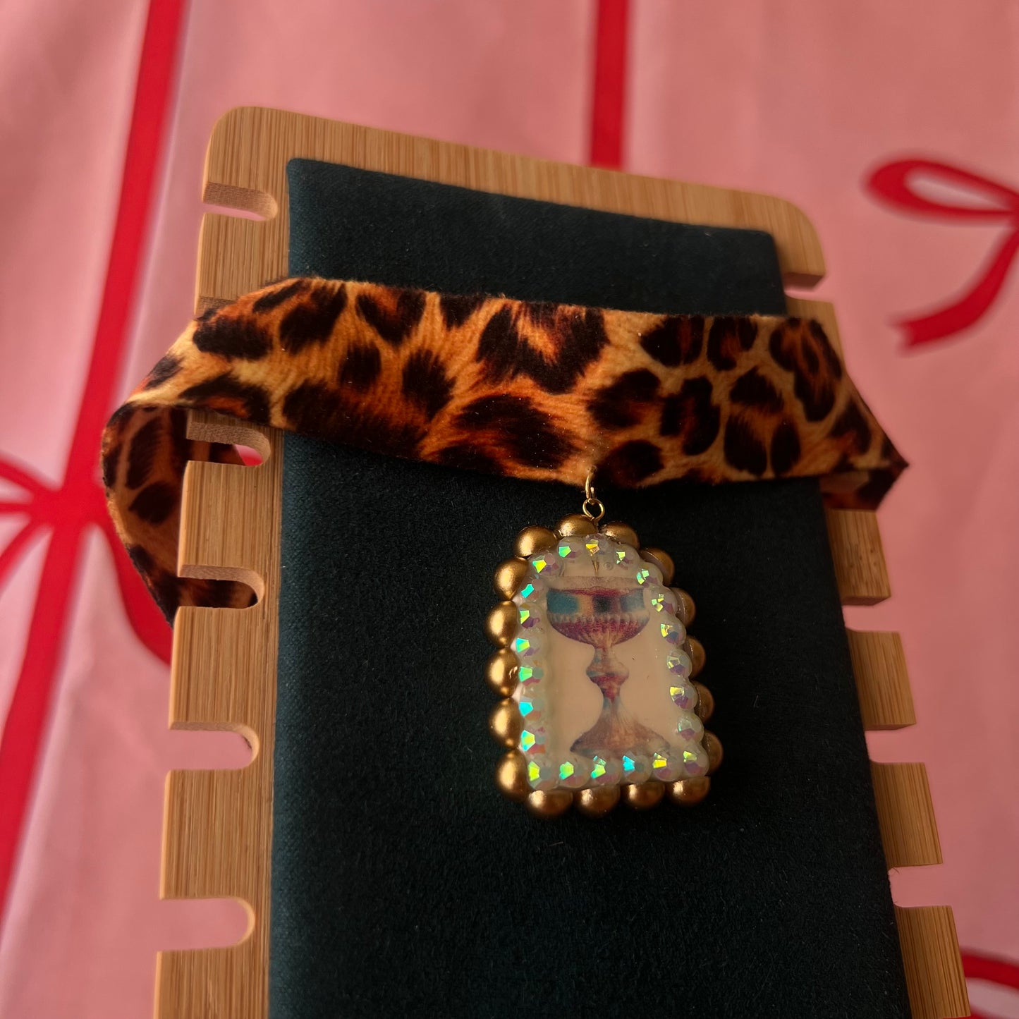 Jungle Elixir choker — soft cheetah print choker with handmade polymer clay fantasy chalice charm framed with bronze pearls and iridescent rhinestones. Adjustable fit ~14–16" with extension chain. Gift-ready green Victorian-patterned box + bow. Ready to ship in 1–3 days.