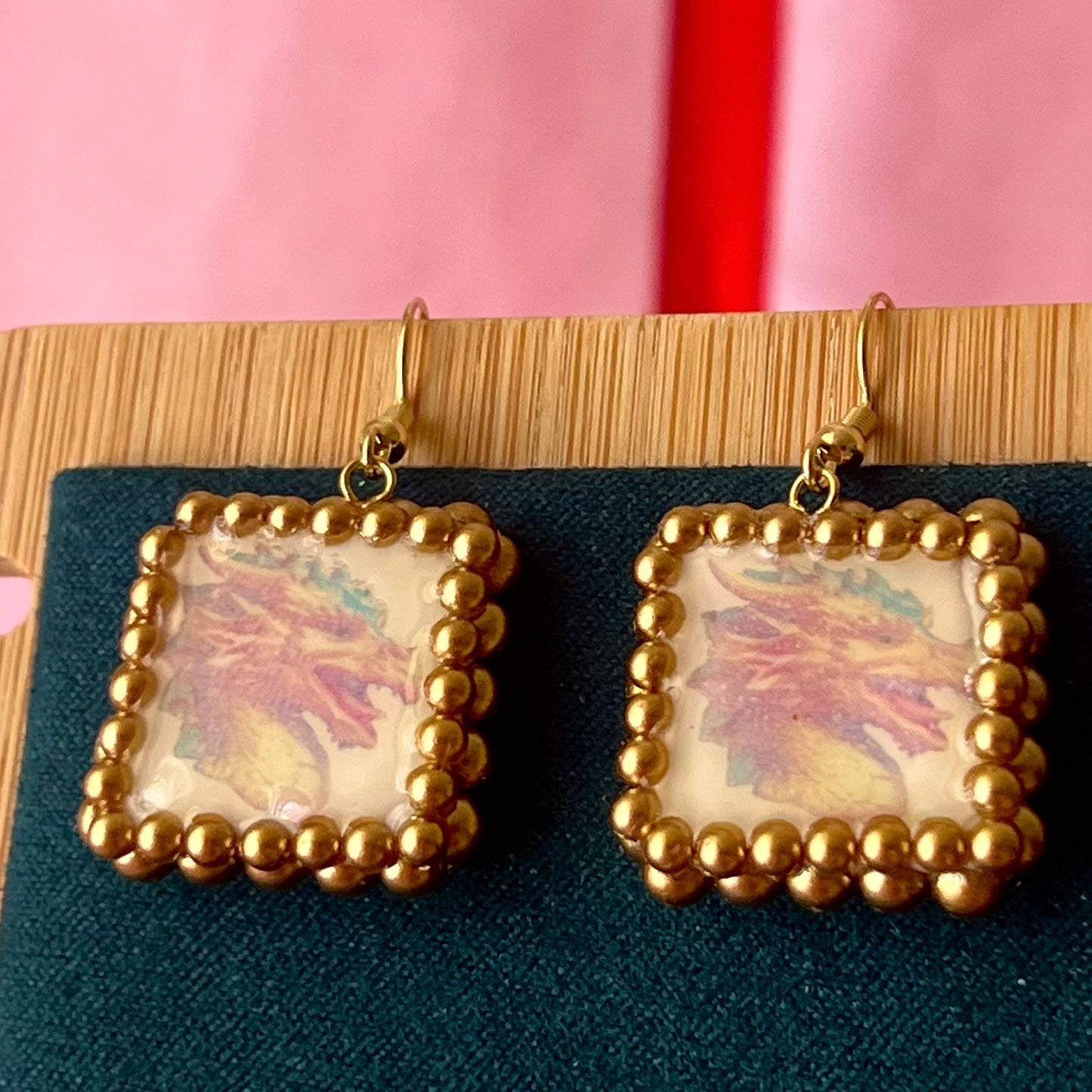 Handmade medieval gold dragon earrings—polymer‑clay dragon charms painted metallic gold, framed with gold pearls, featuring 18k gold‑plated findings and hypoallergenic hooks, perfect fantasy/medievalcore statement jewelry.
