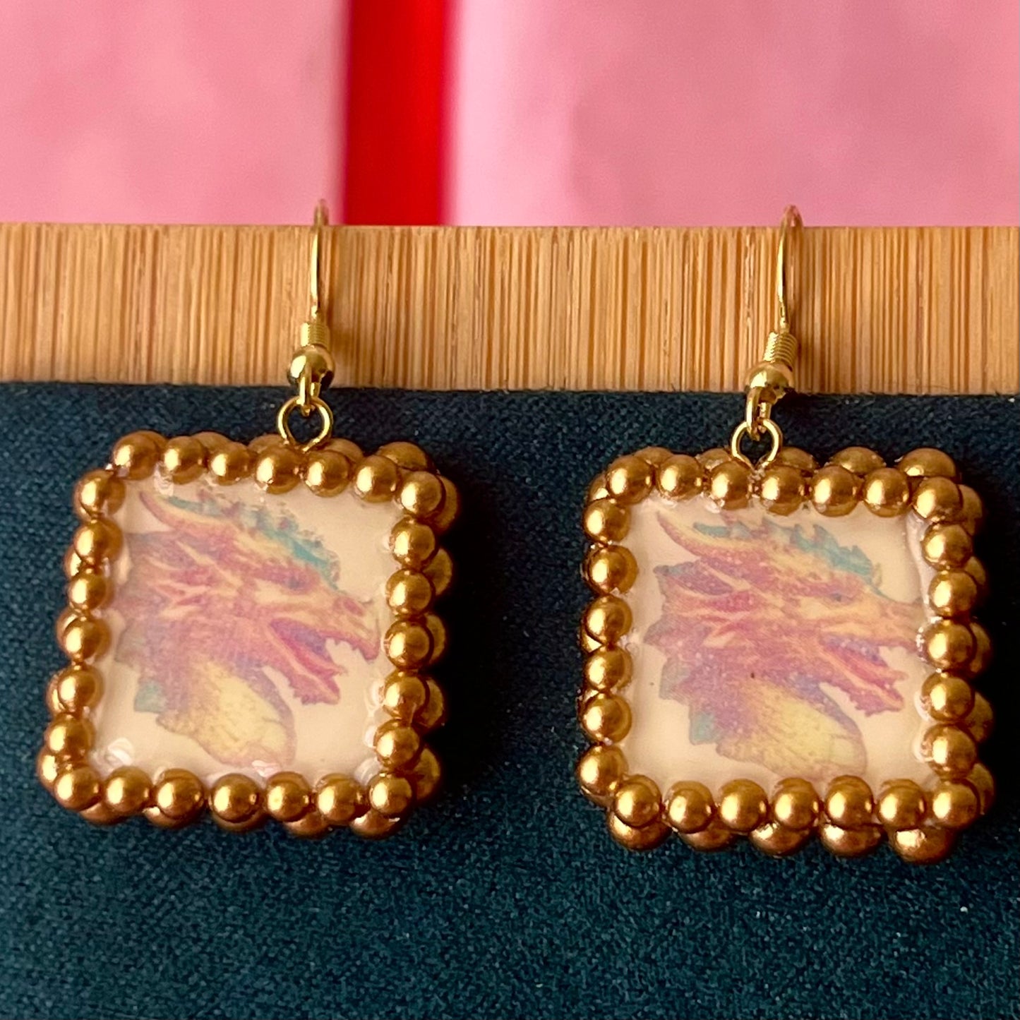 Handmade medieval gold dragon earrings—polymer‑clay dragon charms painted metallic gold, framed with gold pearls, featuring 18k gold‑plated findings and hypoallergenic hooks, perfect fantasy/medievalcore statement jewelry.