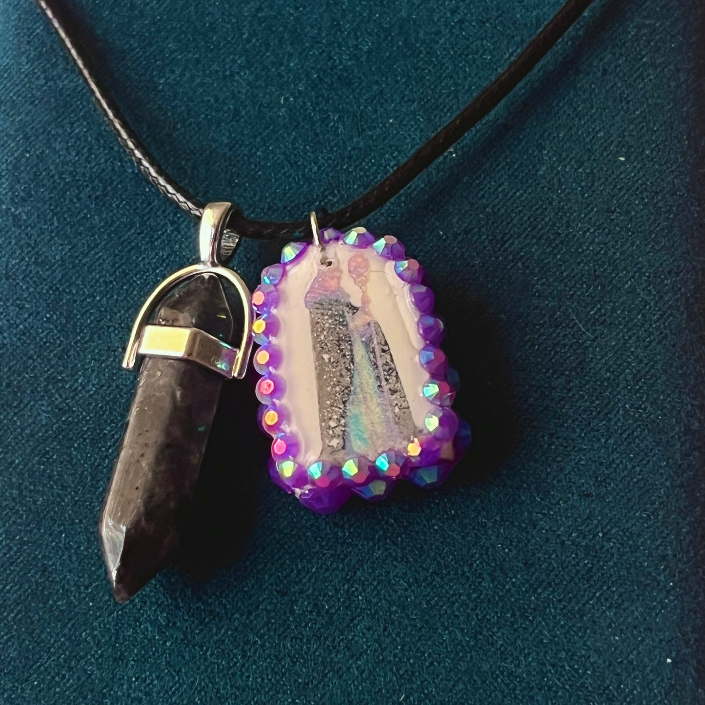 Medieval sorceress polymer charm necklace — black vegan leather chain with black marbled stone pendant plus arched sorceress charm (approx. 1" x 0.75") featuring staff + glowing orb, bedazzled with purple iridescent pearls. Dark medievalcore / fantasy talisman jewelry; ready to ship.