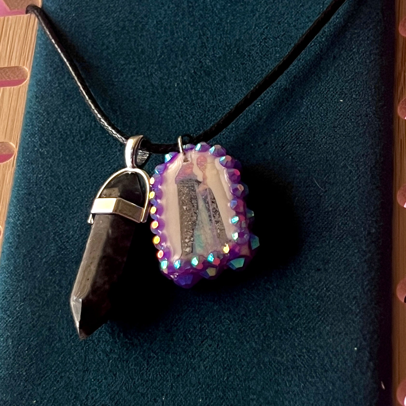 Medieval sorceress polymer charm necklace — black vegan leather chain with black marbled stone pendant plus arched sorceress charm (approx. 1" x 0.75") featuring staff + glowing orb, bedazzled with purple iridescent pearls. Dark medievalcore / fantasy talisman jewelry; ready to ship.