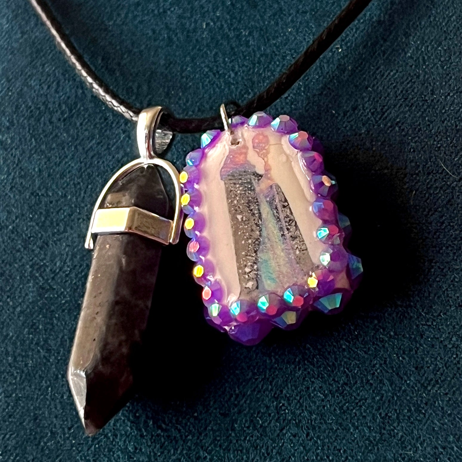 Medieval sorceress polymer charm necklace — black vegan leather chain with black marbled stone pendant plus arched sorceress charm (approx. 1" x 0.75") featuring staff + glowing orb, bedazzled with purple iridescent pearls. Dark medievalcore / fantasy talisman jewelry; ready to ship.