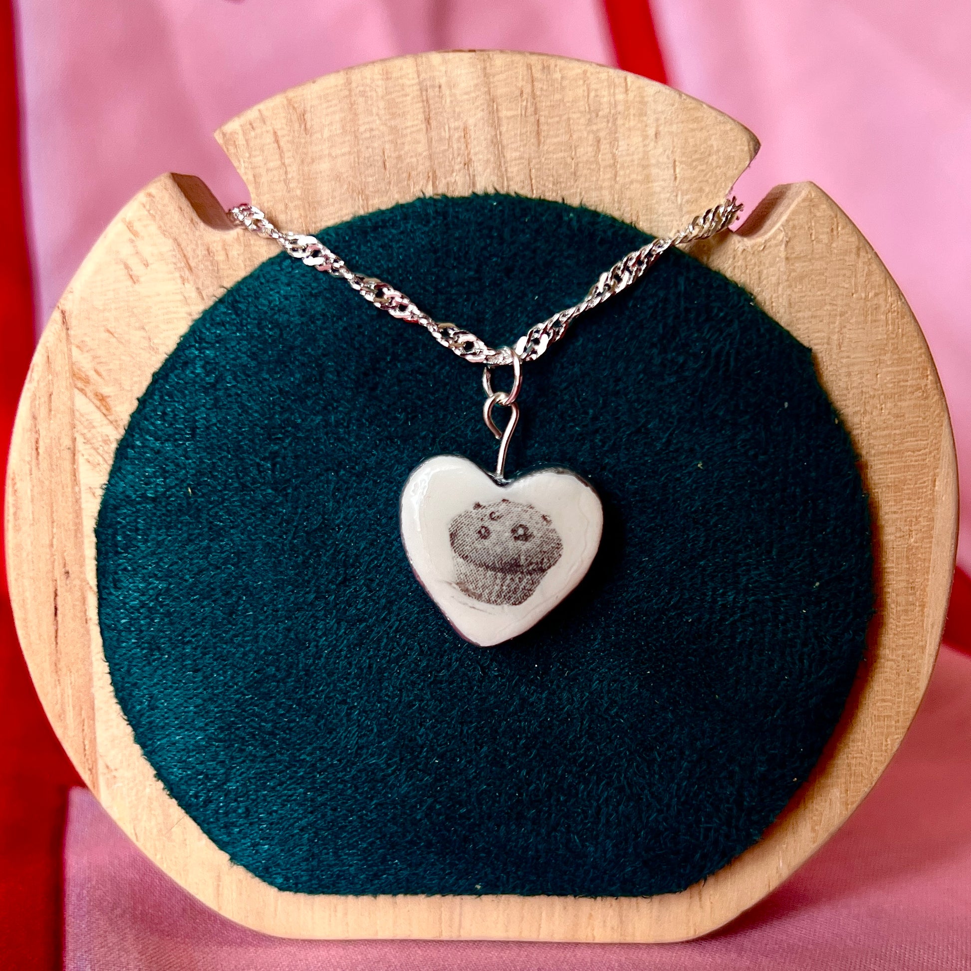 Muffin Man’s Heart blueberry muffin necklace — handmade monochrome polymer clay blueberry muffin charm with metallic silver-black finish on 20" 925 sterling silver chain. Bakerycore snackcore Y2K charm necklace; gift-ready black celestial box. Ships in 1–3 business days.
