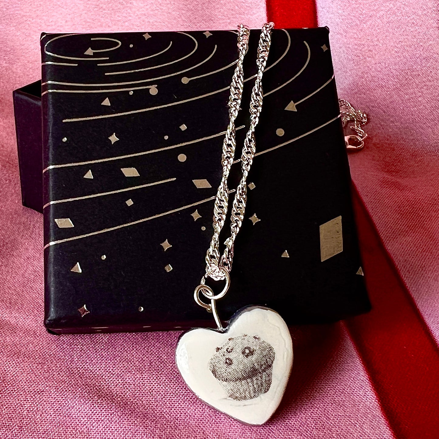 Muffin Man’s Heart blueberry muffin necklace — handmade monochrome polymer clay blueberry muffin charm with metallic silver-black finish on 20" 925 sterling silver chain. Bakerycore snackcore Y2K charm necklace; gift-ready black celestial box. Ships in 1–3 business days.