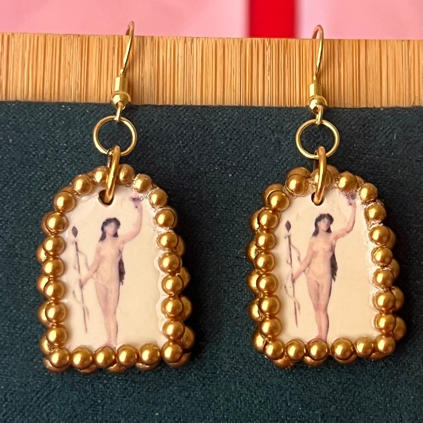 Handmade nude lady earrings featuring bronze polymer‑clay arch charms with an oil‑painting‑style image transfer and a sparkling pearl frame, set on 18k gold‑plated, hypoallergenic findings—perfect museum‑core, renaissance, medieval, coquette, and fairycore jewelry.