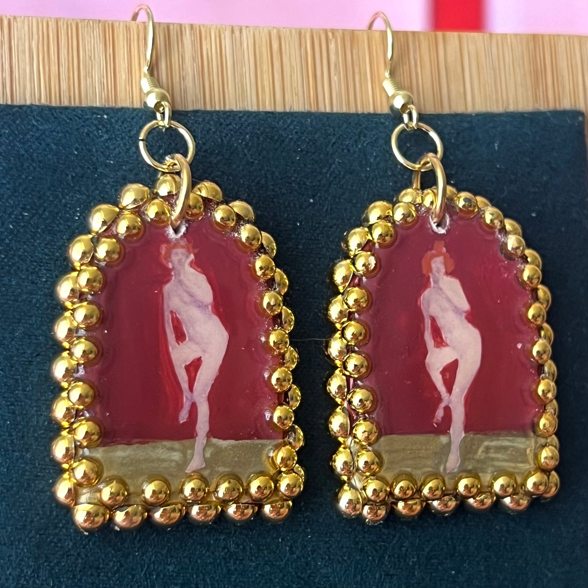 Handmade polymer‑clay arch‑shaped earrings featuring a nude lady art portrait on a deep red background, framed with pearls and finished with 18k gold‑plated hypoallergenic hooks—perfect romantic, coquette, renaissance‑style statement piece.