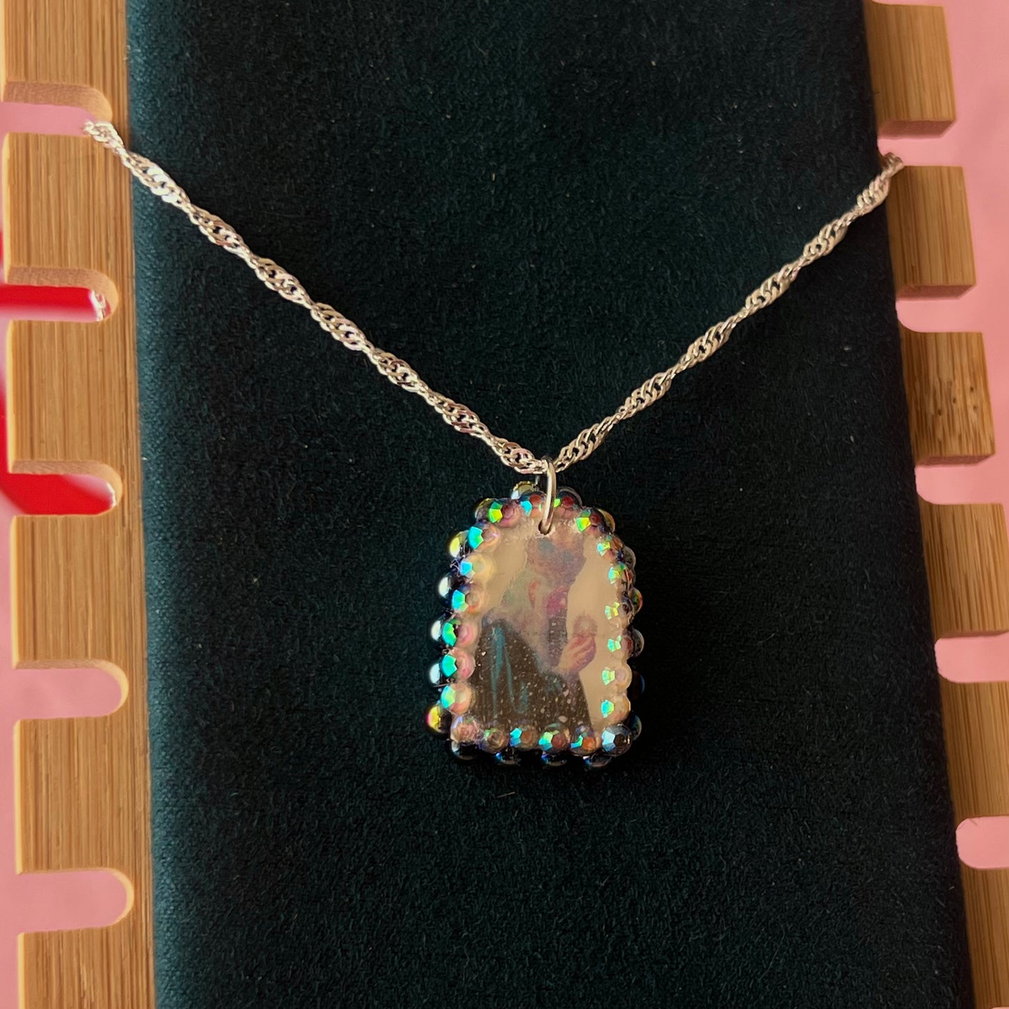Oracle elf necklace — handmade polymer clay medieval-inspired divination elf charm (approx. 1") with iridescent finish, bedazzled with iridescent black pearls + rhinestones on 20" 925 sterling silver chain. Gift-ready Victorian-patterned box with green bow. Ready to ship in 1–3 business days.