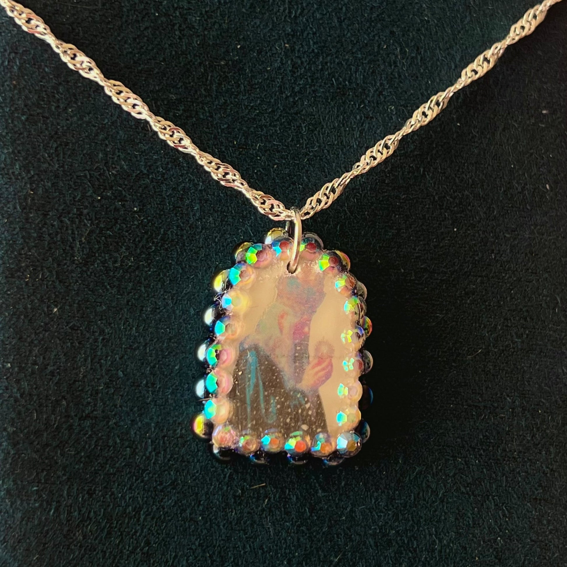 Oracle elf necklace — handmade polymer clay medieval-inspired divination elf charm (approx. 1") with iridescent finish, bedazzled with iridescent black pearls + rhinestones on 20" 925 sterling silver chain. Gift-ready Victorian-patterned box with green bow. Ready to ship in 1–3 business days.