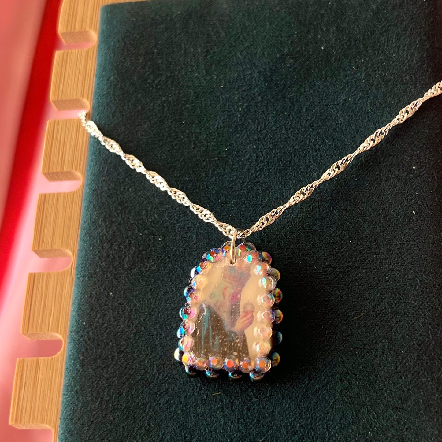 Oracle elf necklace — handmade polymer clay medieval-inspired divination elf charm (approx. 1") with iridescent finish, bedazzled with iridescent black pearls + rhinestones on 20" 925 sterling silver chain. Gift-ready Victorian-patterned box with green bow. Ready to ship in 1–3 business days.