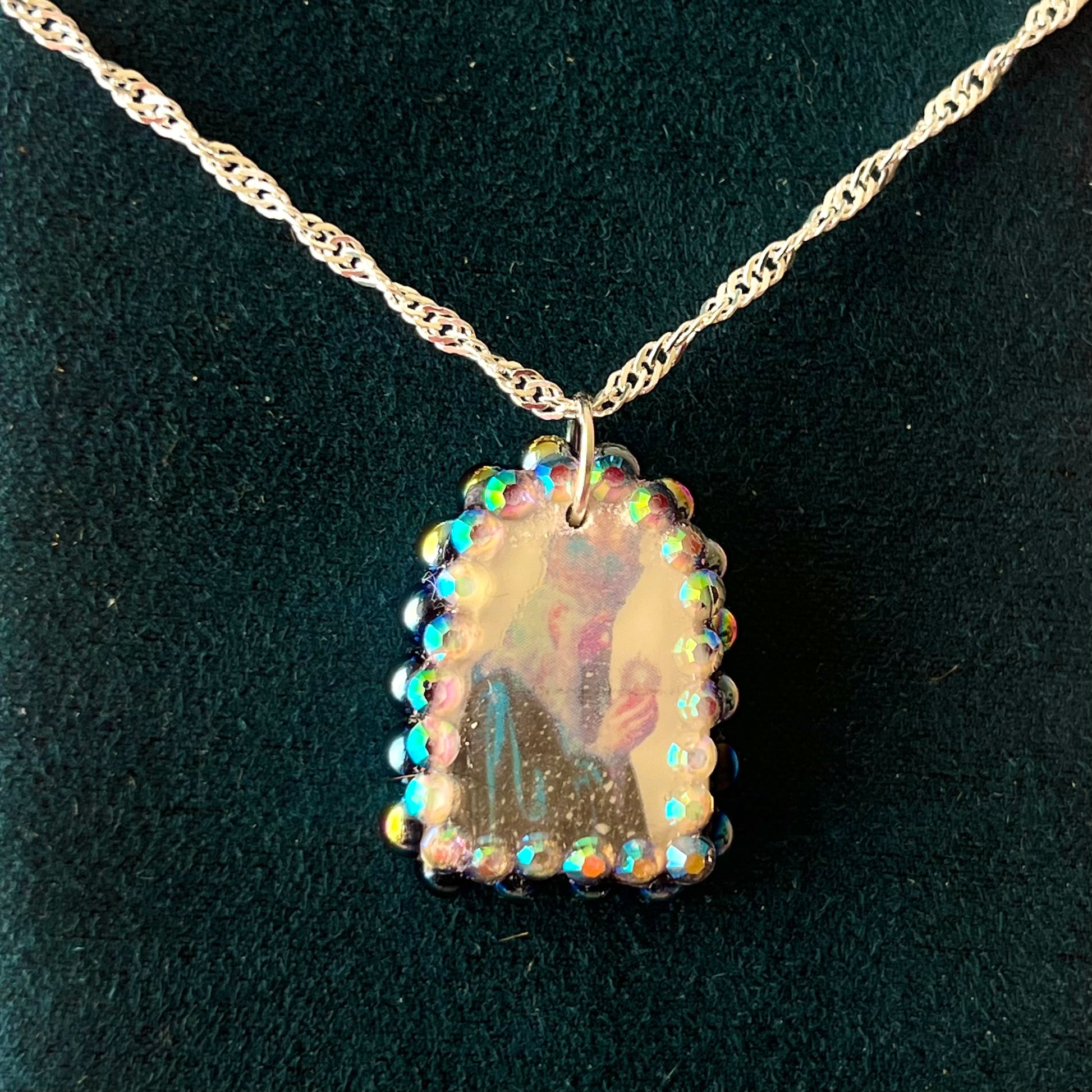 Oracle elf necklace — handmade polymer clay medieval-inspired divination elf charm (approx. 1") with iridescent finish, bedazzled with iridescent black pearls + rhinestones on 20" 925 sterling silver chain. Gift-ready Victorian-patterned box with green bow. Ready to ship in 1–3 business days.