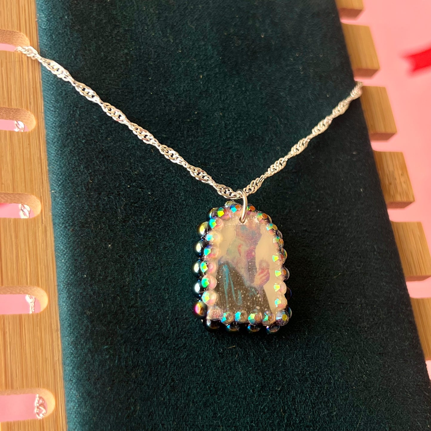 Oracle elf necklace — handmade polymer clay medieval-inspired divination elf charm (approx. 1") with iridescent finish, bedazzled with iridescent black pearls + rhinestones on 20" 925 sterling silver chain. Gift-ready Victorian-patterned box with green bow. Ready to ship in 1–3 business days.