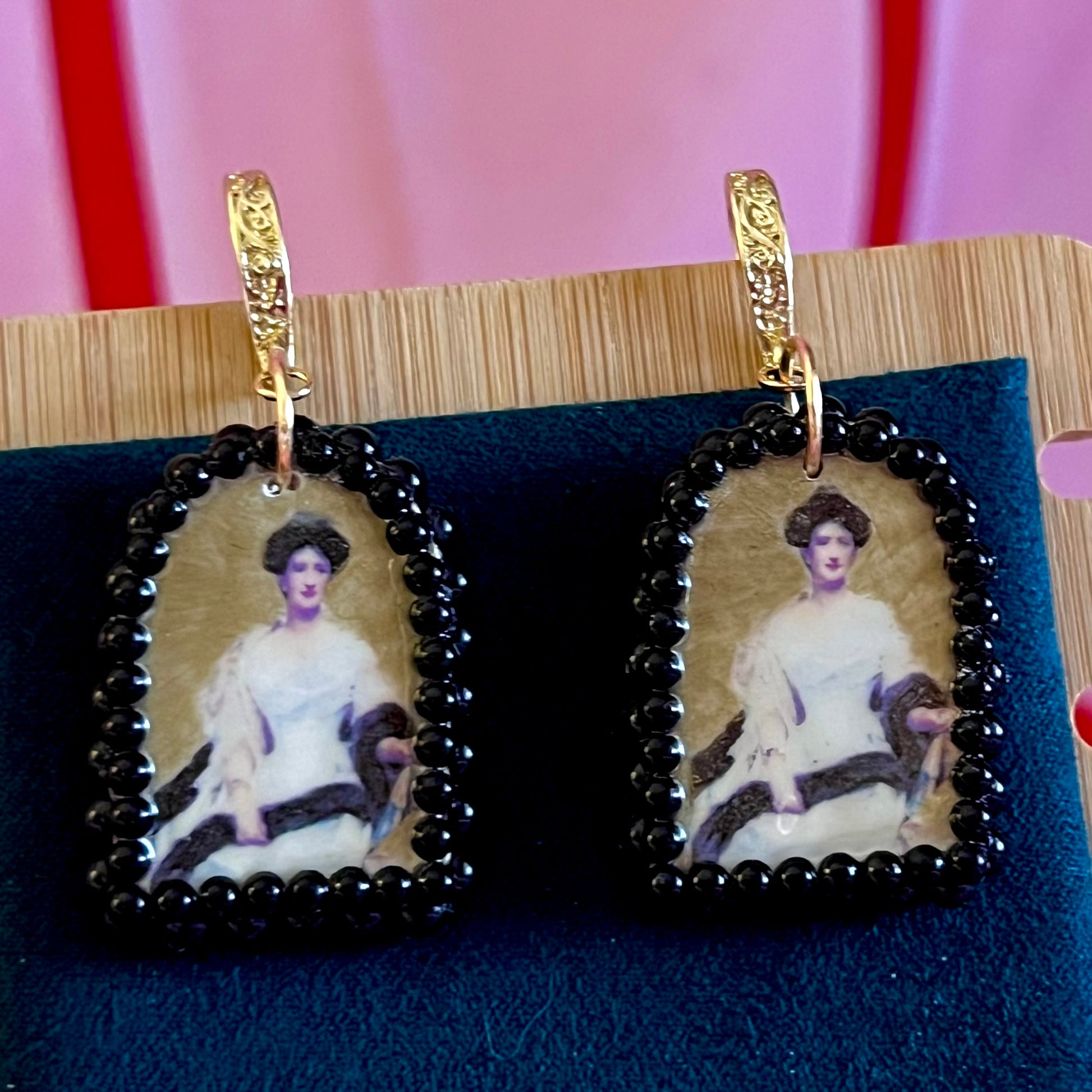 Portrait Of A Lady (1888) by Raimundo de Madrazo y Garreda – large black‑pearl gold arch earrings featuring a polymer‑clay arch charm with a metallic gold background and a transferred portrait image, framed in dark black pearls and finished with ornate 18k gold‑plated Victorian‑inspired filigree; a museum‑style, romantic statement piece.
