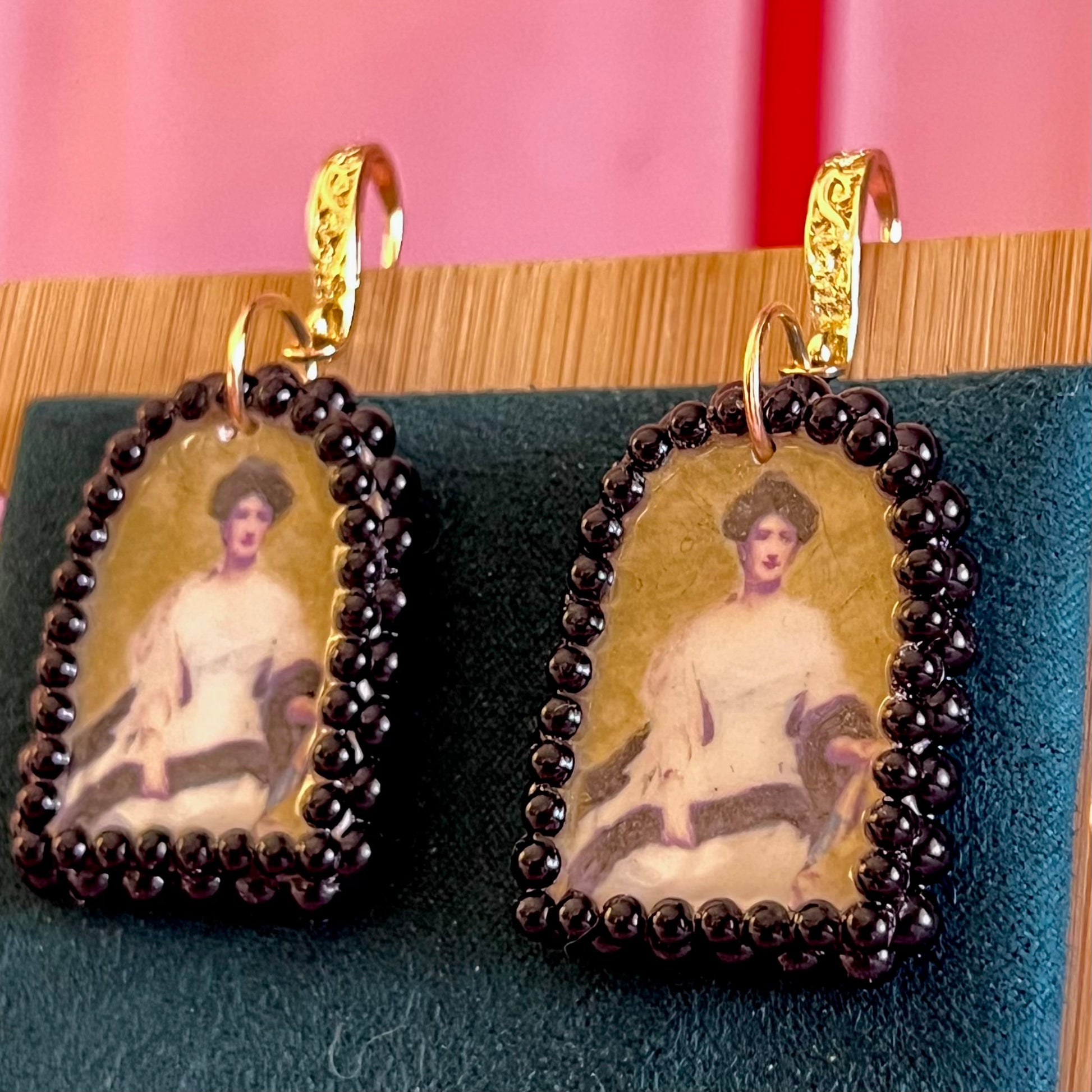 Portrait Of A Lady (1888) by Raimundo de Madrazo y Garreda – large black‑pearl gold arch earrings featuring a polymer‑clay arch charm with a metallic gold background and a transferred portrait image, framed in dark black pearls and finished with ornate 18k gold‑plated Victorian‑inspired filigree; a museum‑style, romantic statement piece.