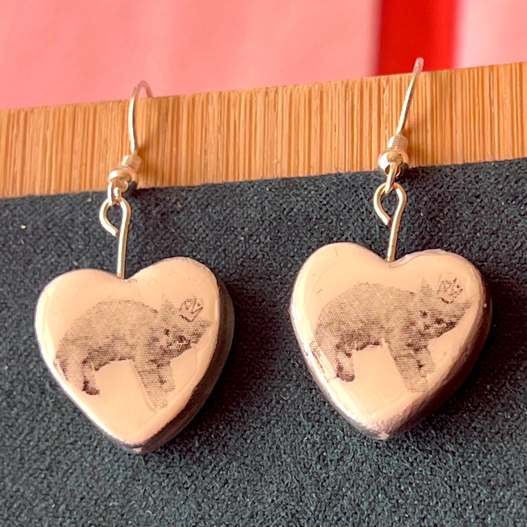 Alt text: Handmade white polymer‑clay heart earrings featuring a black‑and‑white crowned kitten, described as sweet, slightly regal, and perfect for coquette/kawaii styling, with hypoallergenic silver‑plated hooks; ideal cat‑lover gift and cute statement jewelry.