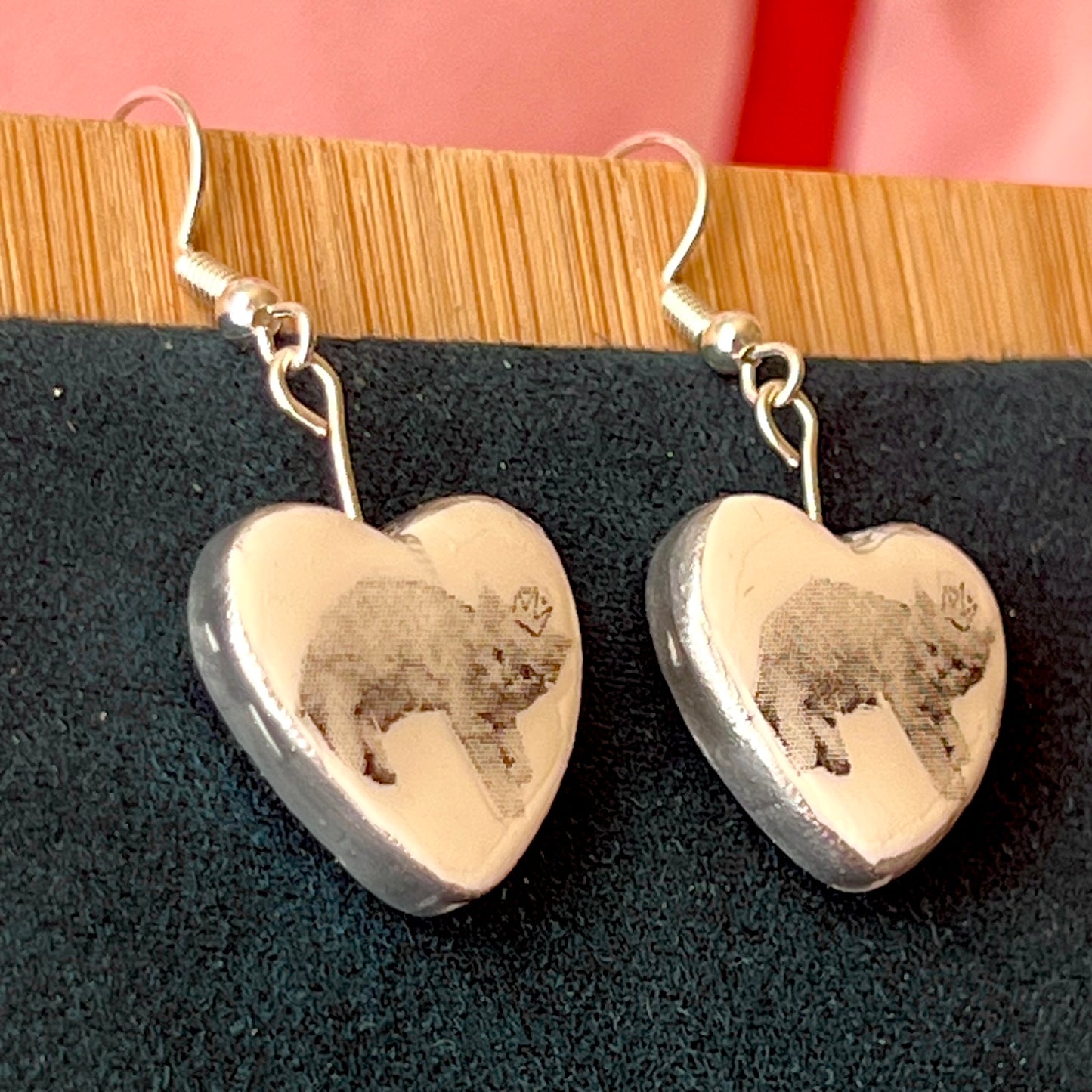Alt text: Handmade white polymer‑clay heart earrings featuring a black‑and‑white crowned kitten, described as sweet, slightly regal, and perfect for coquette/kawaii styling, with hypoallergenic silver‑plated hooks; ideal cat‑lover gift and cute statement jewelry.