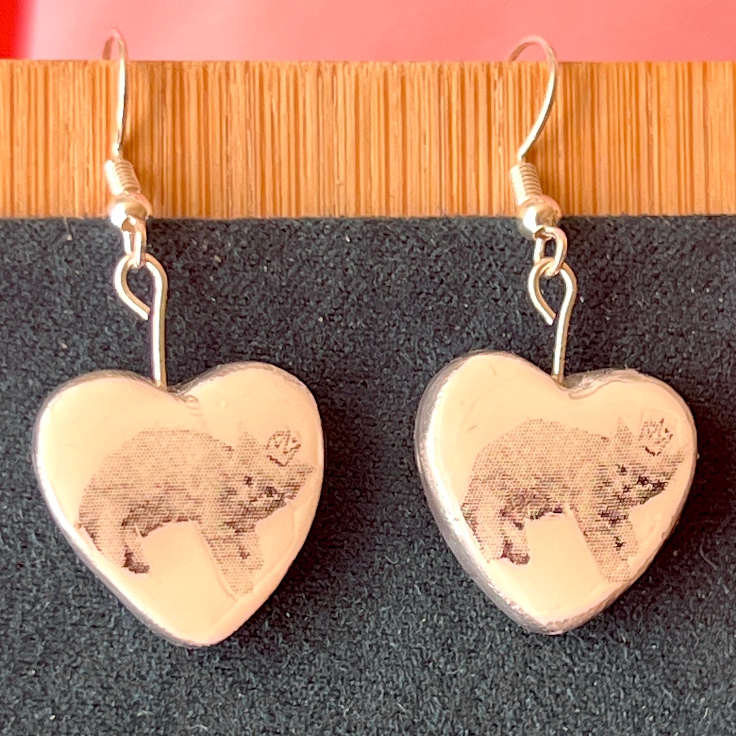 Alt text: Handmade white polymer‑clay heart earrings featuring a black‑and‑white crowned kitten, described as sweet, slightly regal, and perfect for coquette/kawaii styling, with hypoallergenic silver‑plated hooks; ideal cat‑lover gift and cute statement jewelry.