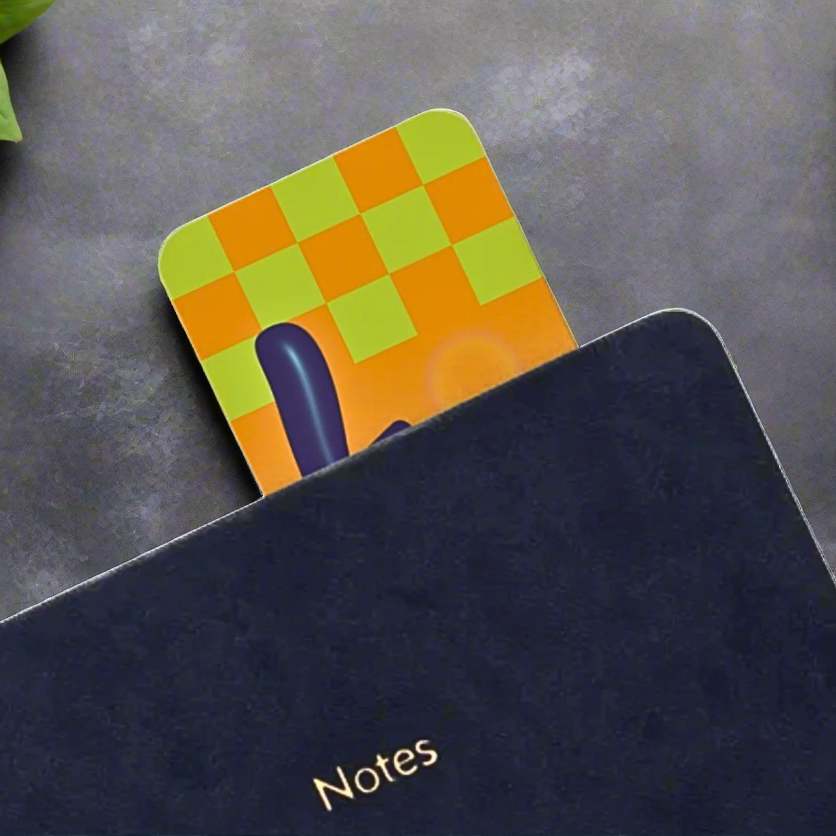 Black notebook with a colorful checkered bookmark on a white background