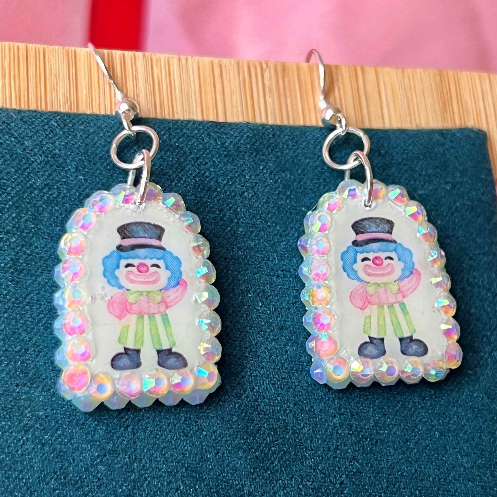 Alt text: Sparkly clown earrings—handmade polymer clay charms bedazzled with iridescent pearls and rhinestones, featuring silver‑plated hypoallergenic hooks. Perfect clowncore, kawaii, circuscore statement jewelry for festivals and alt fashion.