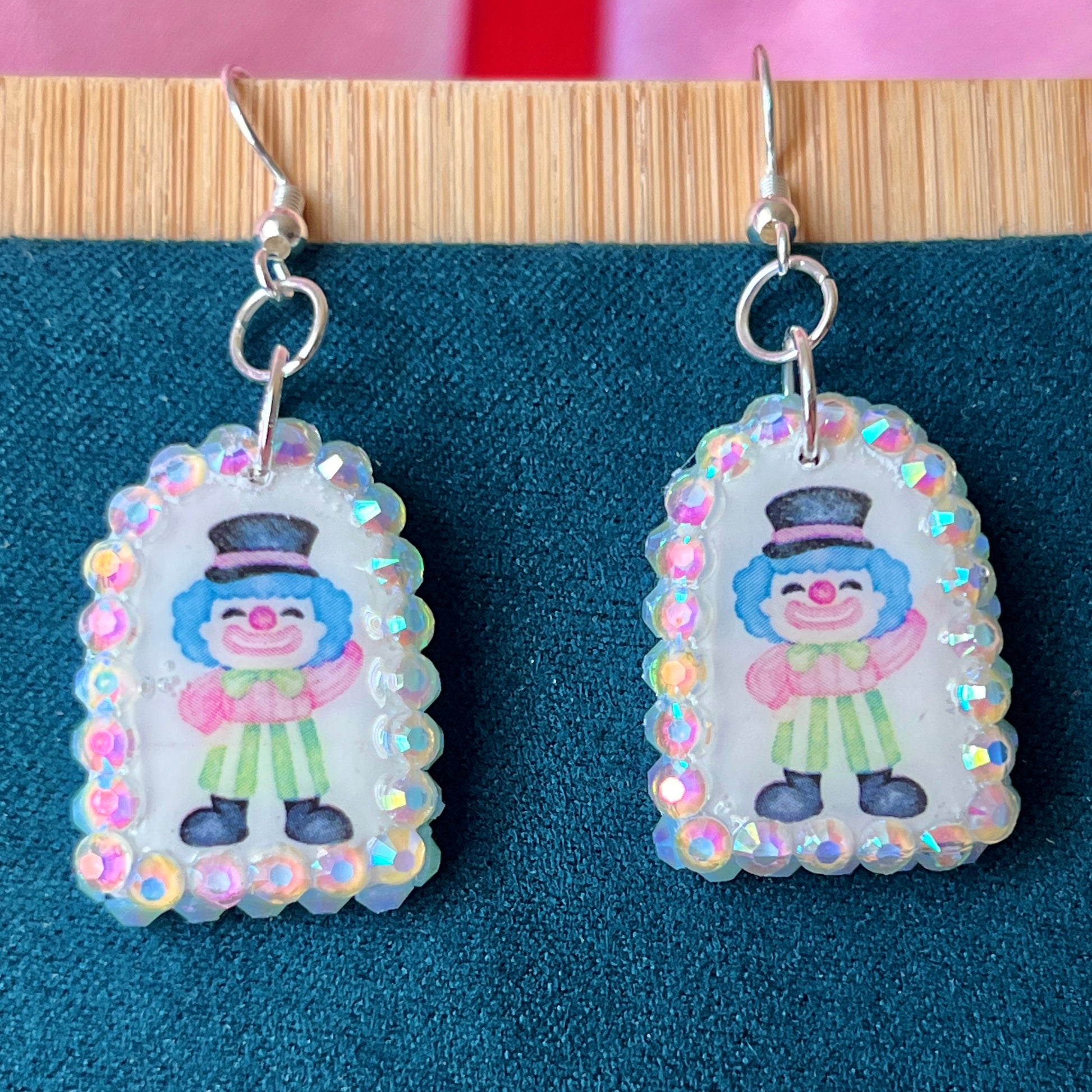 Alt text: Sparkly clown earrings—handmade polymer clay charms bedazzled with iridescent pearls and rhinestones, featuring silver‑plated hypoallergenic hooks. Perfect clowncore, kawaii, circuscore statement jewelry for festivals and alt fashion.