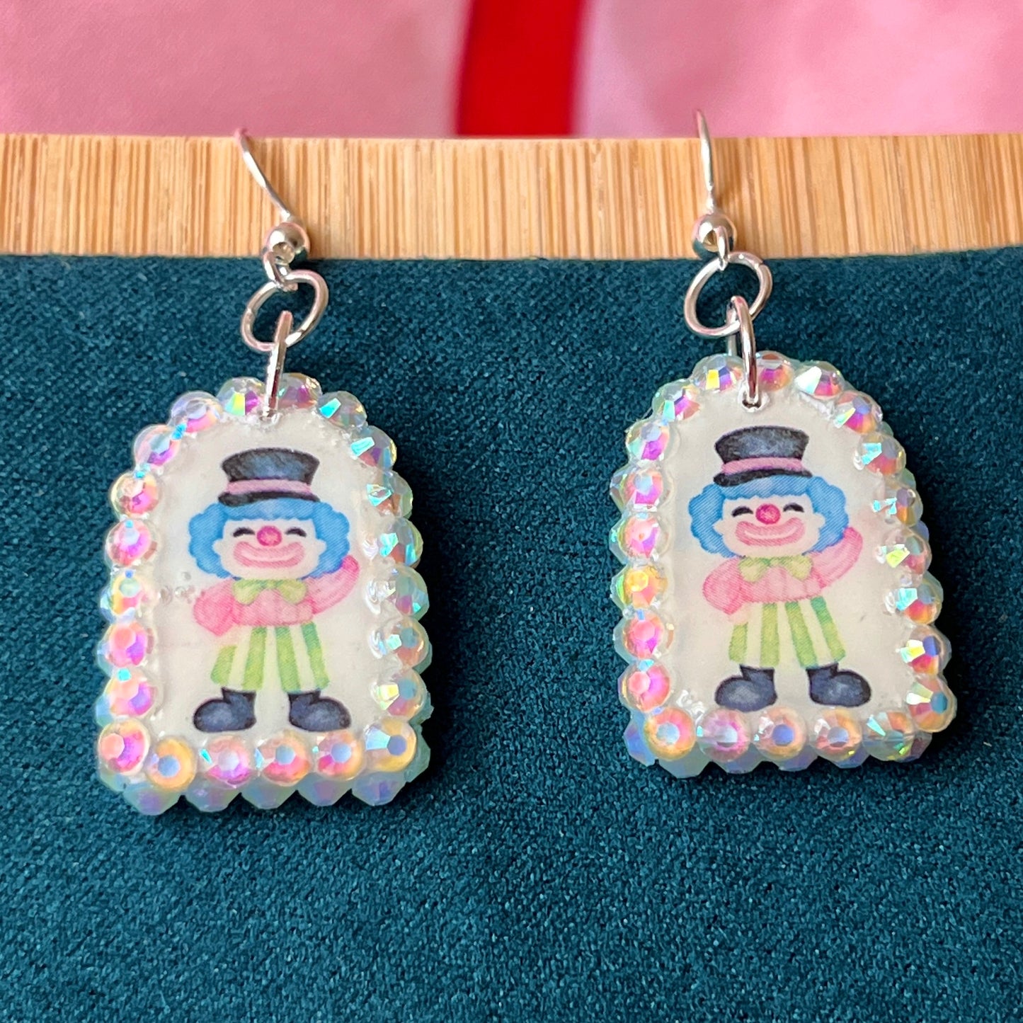Alt text: Sparkly clown earrings—handmade polymer clay charms bedazzled with iridescent pearls and rhinestones, featuring silver‑plated hypoallergenic hooks. Perfect clowncore, kawaii, circuscore statement jewelry for festivals and alt fashion.